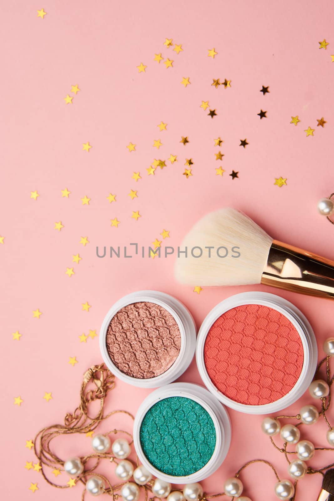 eyeshadow accessories beads makeup brushes collection professional cosmetics on pink background. High quality photo