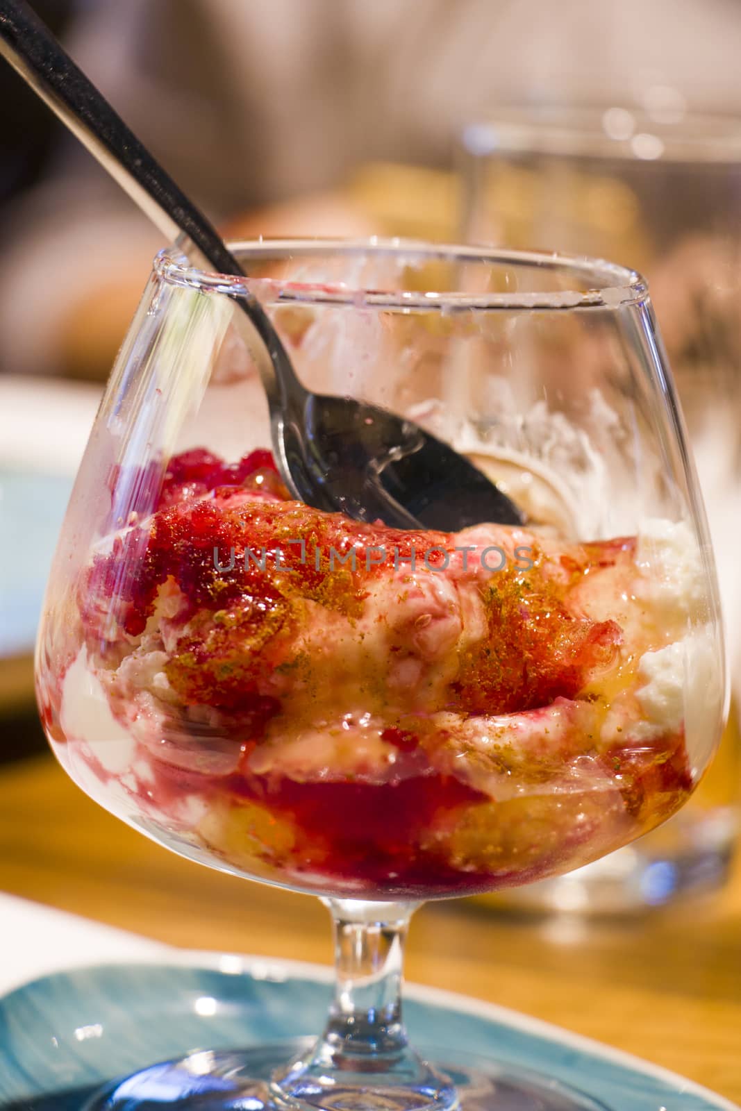 Sweet food dessert in glass with jam and greek yoghurt.