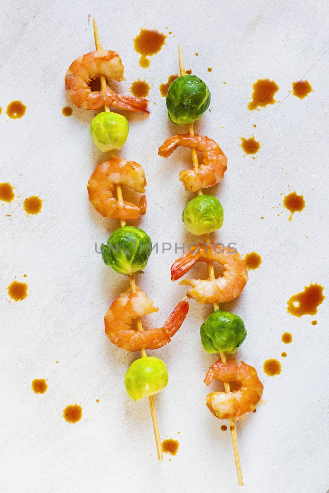 Shrimps and cabbage kebab with souse and lemon, on the table, studio shot. Seafood photography.