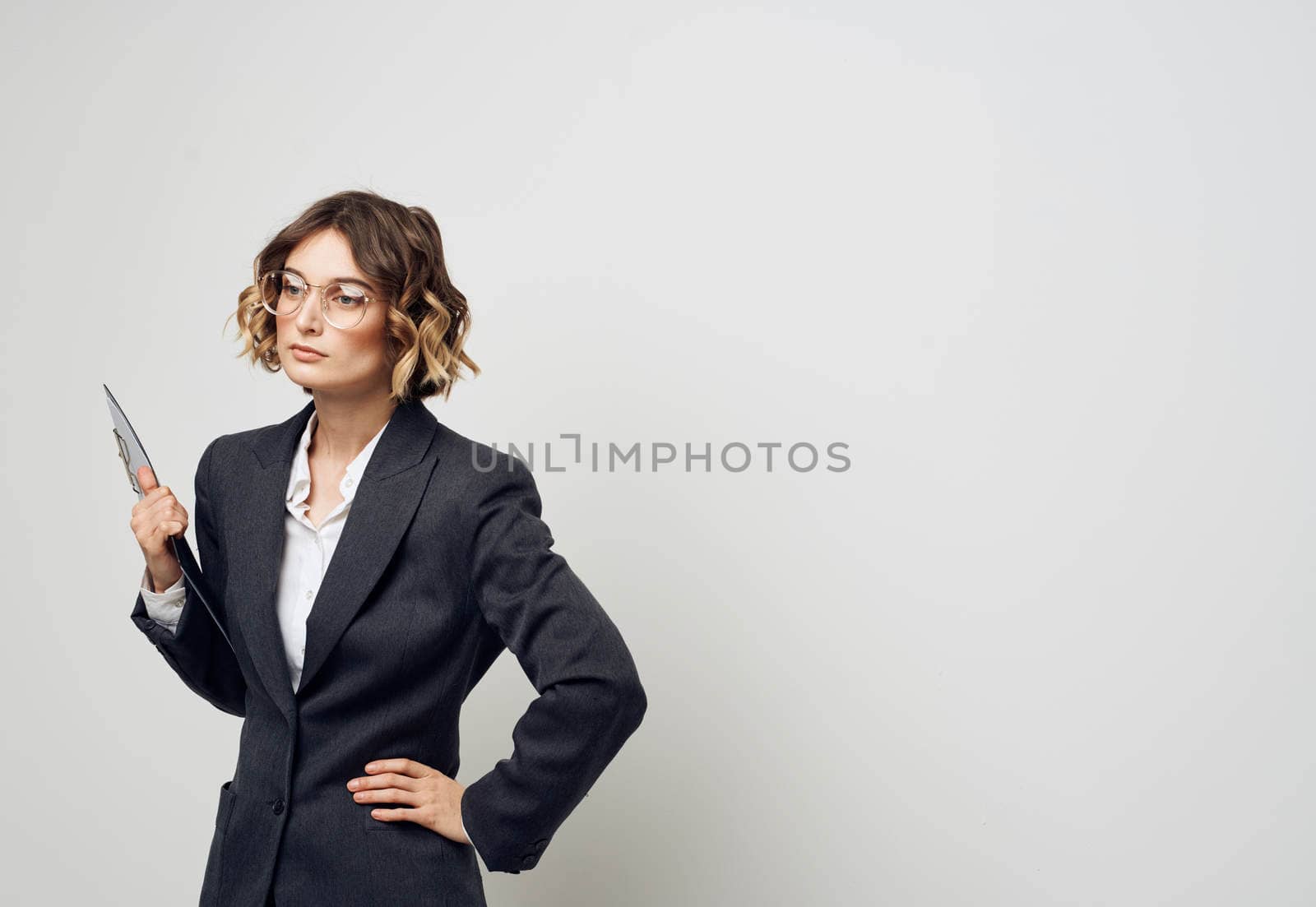 Business woman with documents in hands on a light background indoors. High quality photo