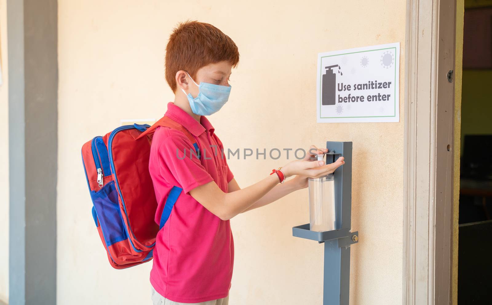 Kid with medical mask using hand sanitizer before entering classroom - concept of back to school or school reopen and coronavirus or covid-19 safety measures. by lakshmiprasad.maski@gmai.com