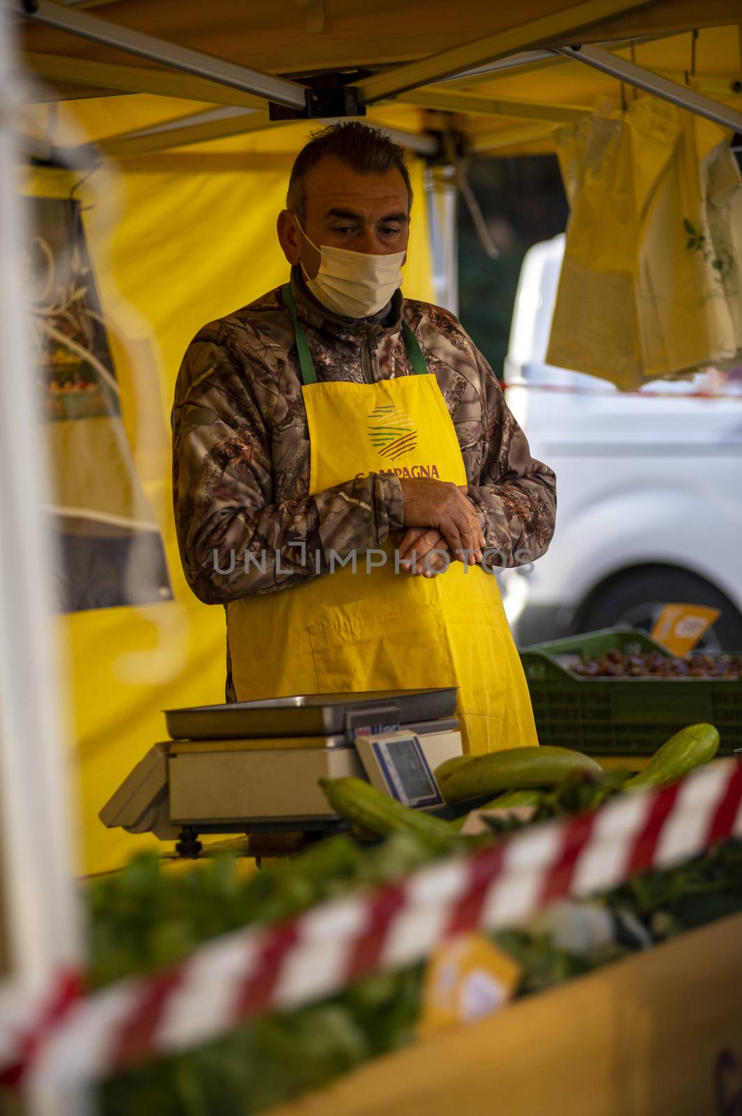 terni,italy october 23 2020:walking man with medical mask at the market selling vegetables