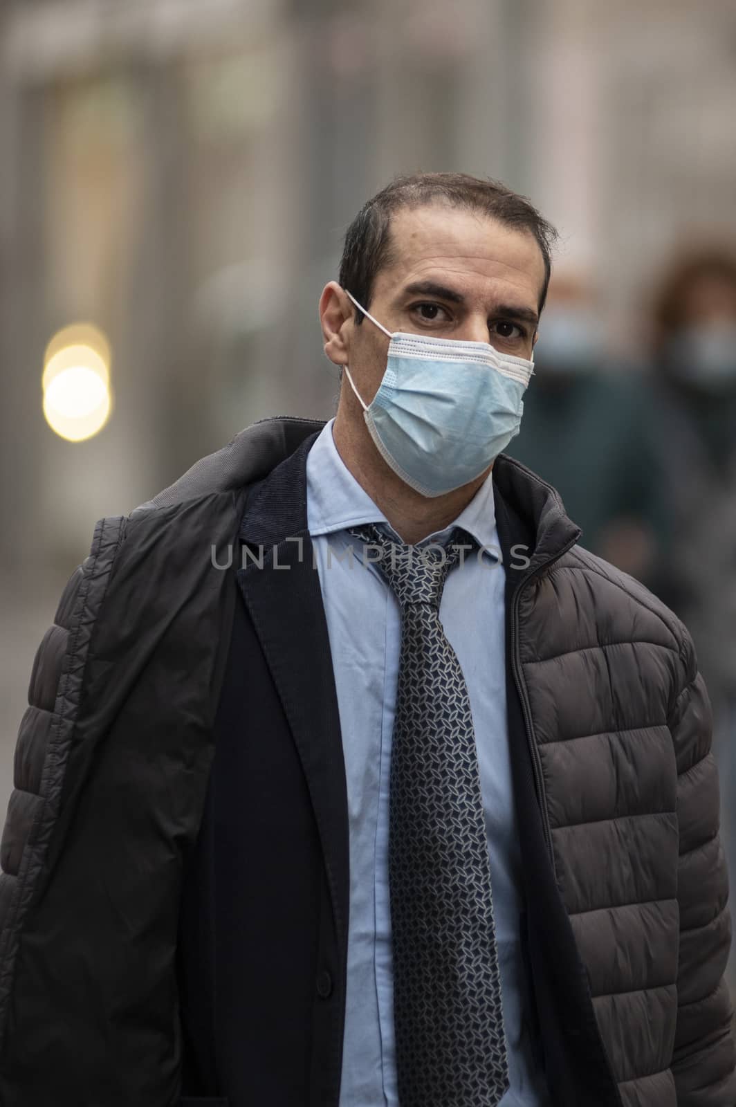 successful man with medical mask in the city by carfedeph