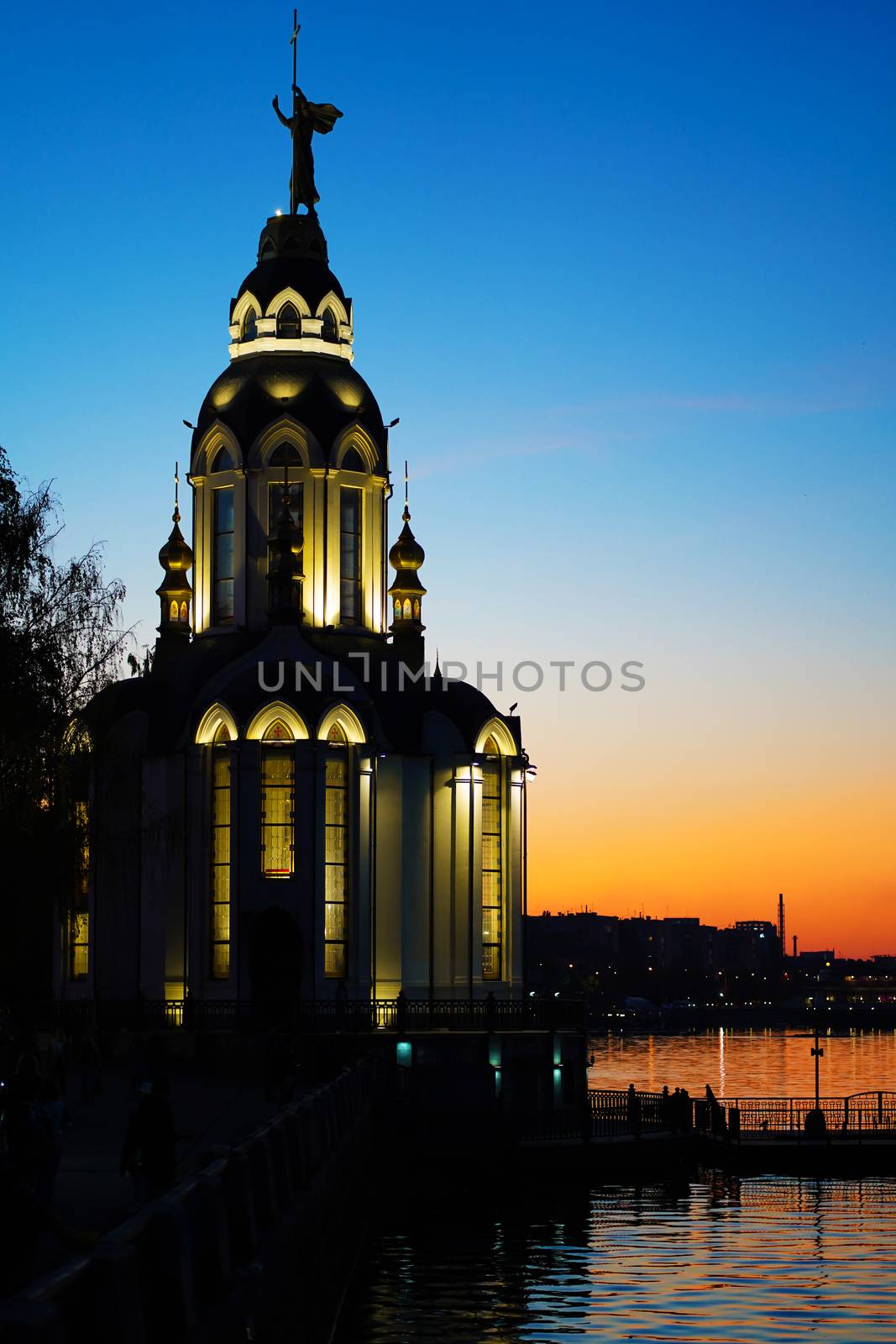 Christian temple by the water at sunset.