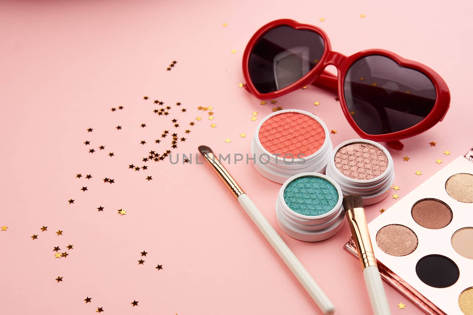 eyeshadow accessories beads makeup brushes collection professional cosmetics on pink background. High quality photo