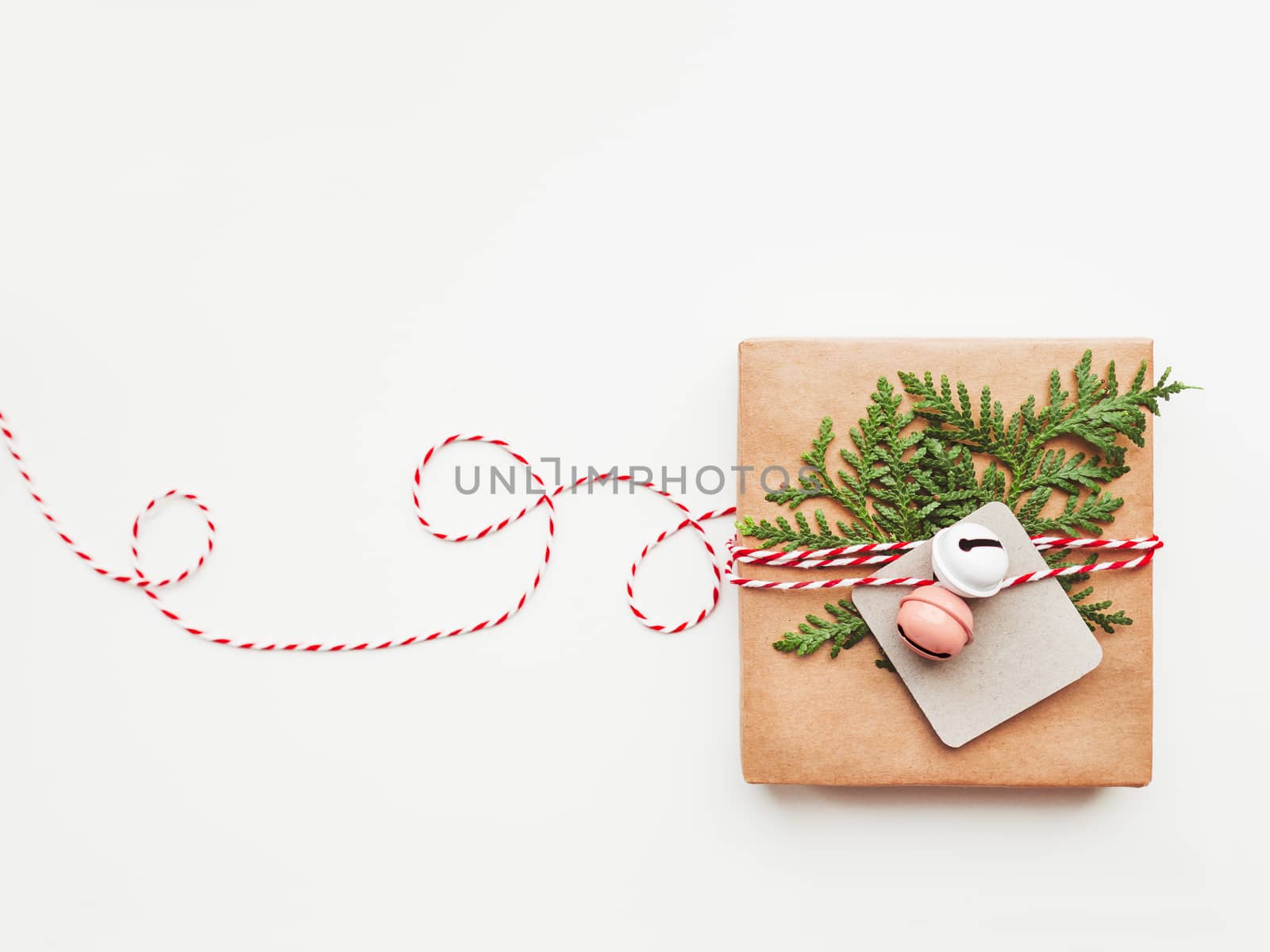 Christmas DIY presents wrapped in craft paper with fir tree branches and red hearts. Top view on decorations on New Year gifts. Festive background. Winter holiday spirit. Banner with copy space.