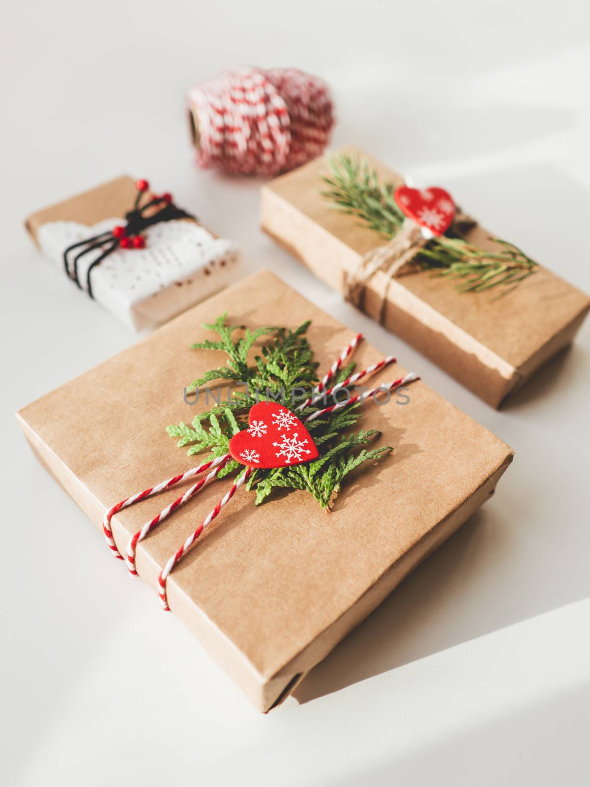 Christmas DIY presents wrapped in craft paper with fir tree bran by aksenovko