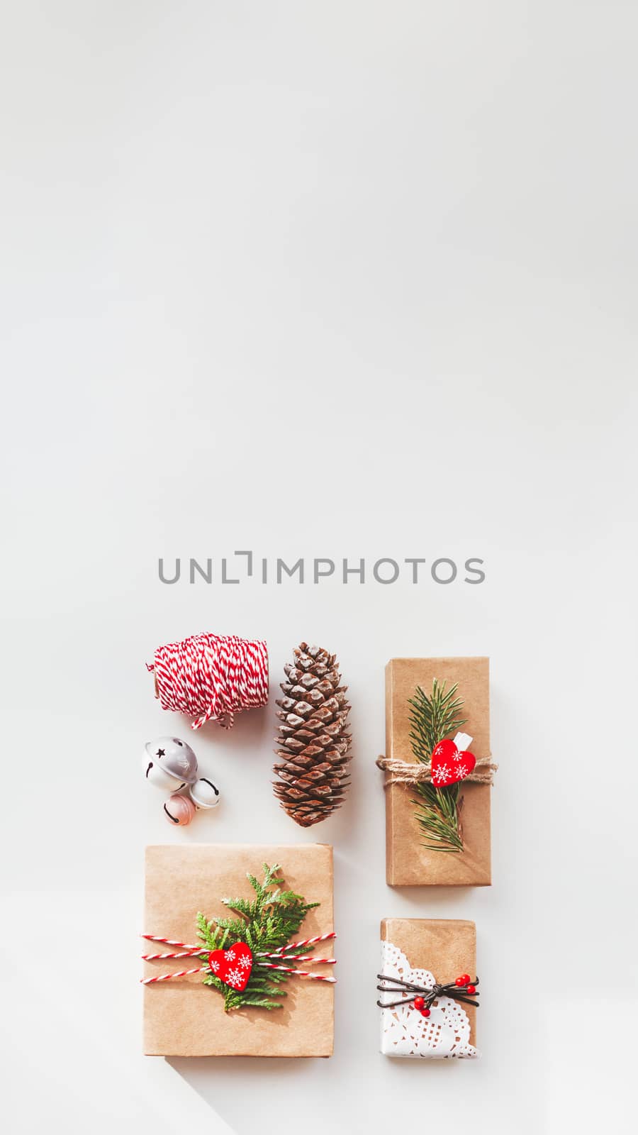 Christmas DIY presents wrapped in craft paper with fir tree twig by aksenovko