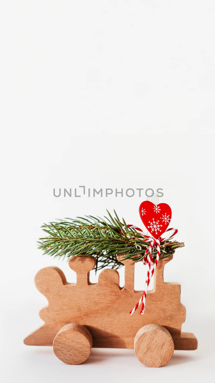 Wooden train with tied fir tree branches and red heart decoratio by aksenovko