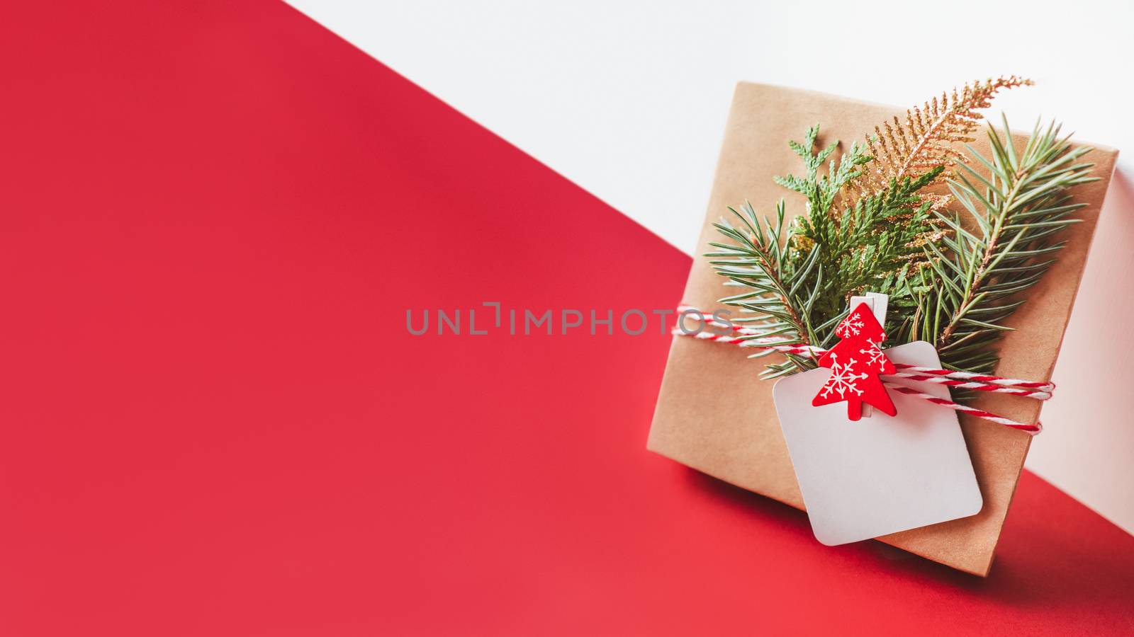 New Year present on geometrical white and red festive background by aksenovko