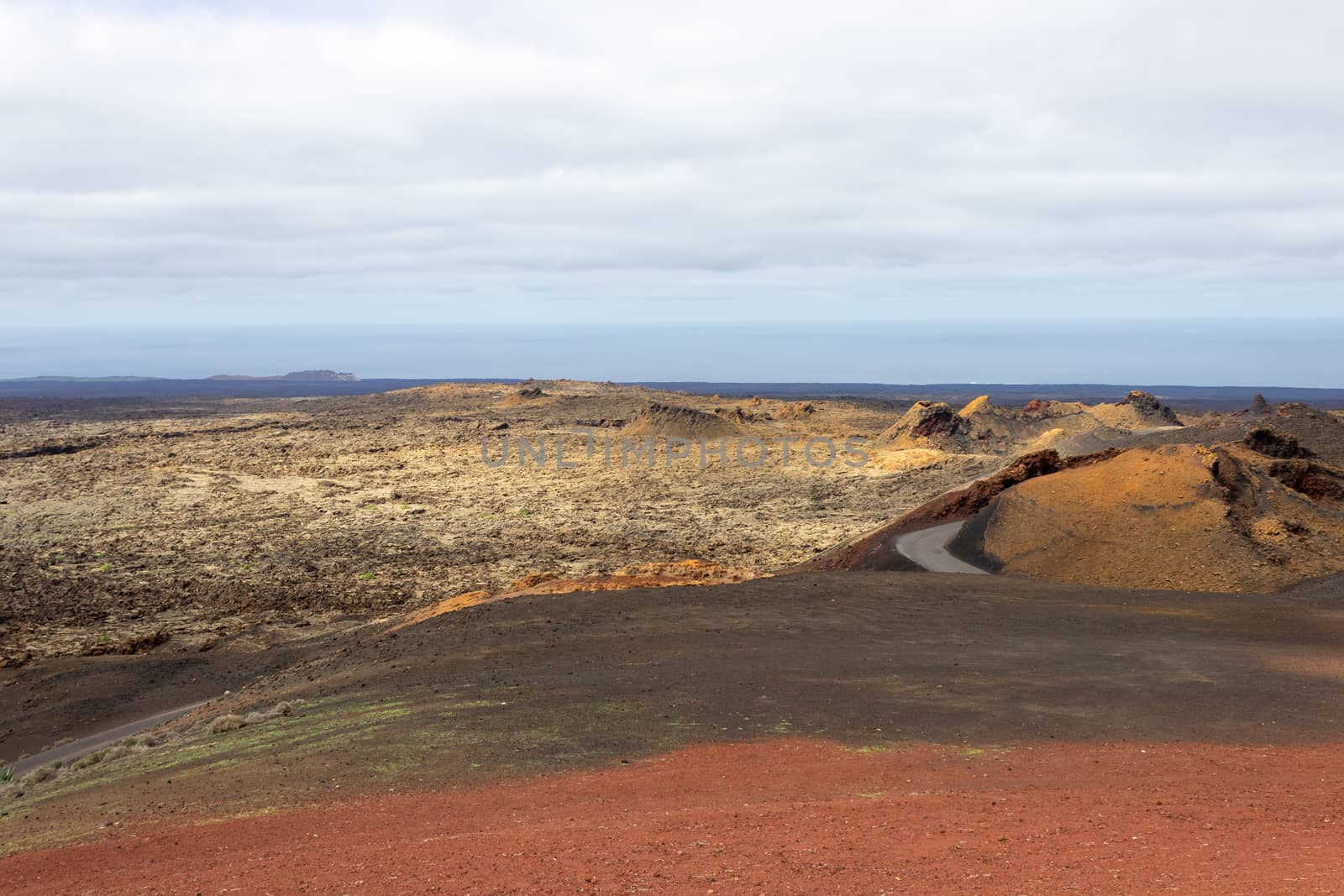 View at multi colored volcanic landscape in Timanfaya Nationalpark on canary island Lanzarote, Spain 