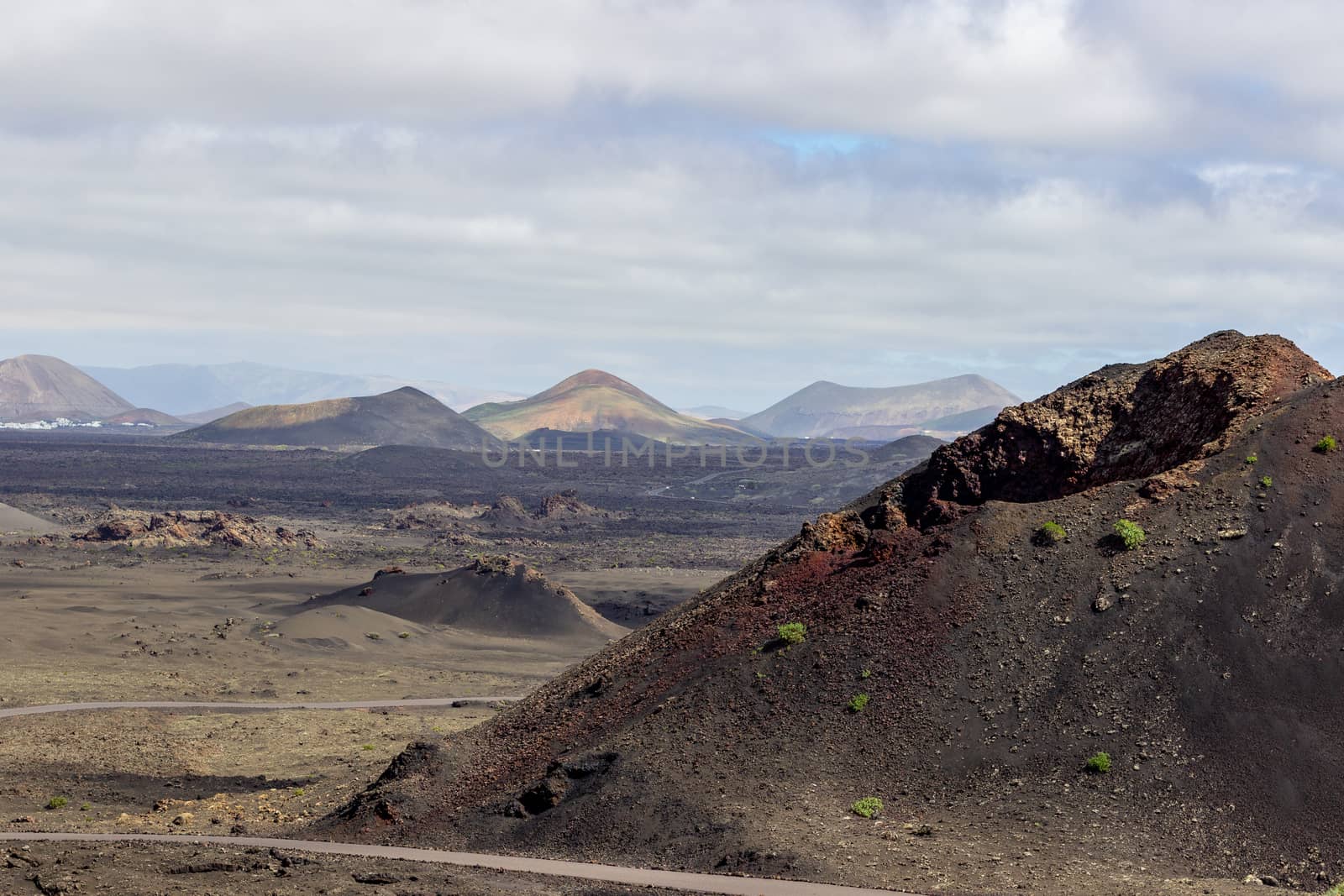 View at multi colored volcanic landscape in Timanfaya Nationalpark on canary island Lanzarote, Spain 