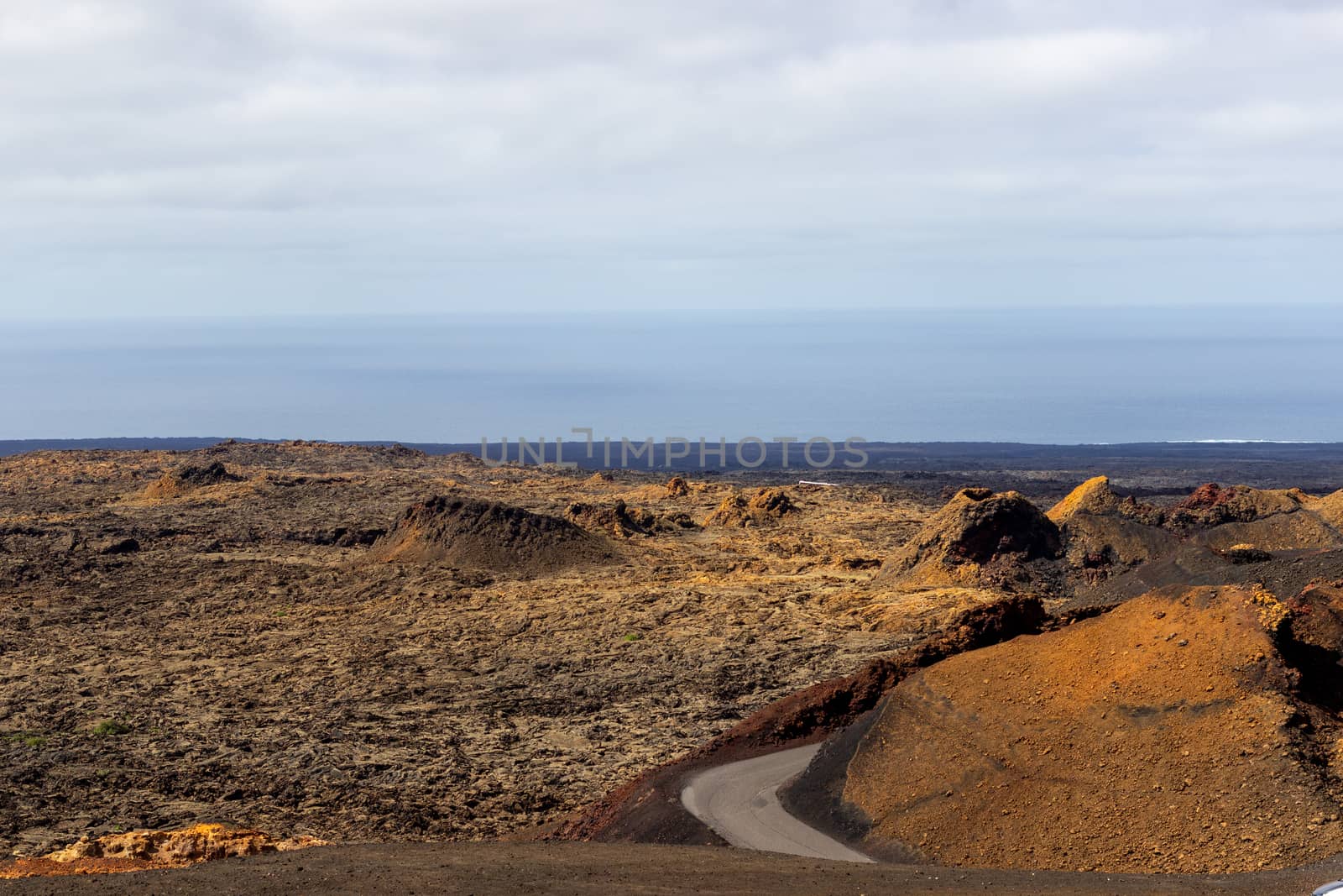 View at multi colored volcanic landscape in Timanfaya Nationalpa by reinerc