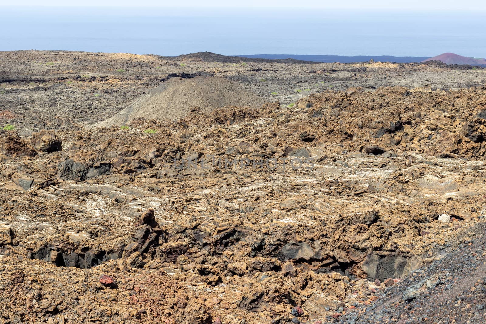 View at multi colored volcanic landscape in Timanfaya Nationalpark on canary island Lanzarote, Spain 