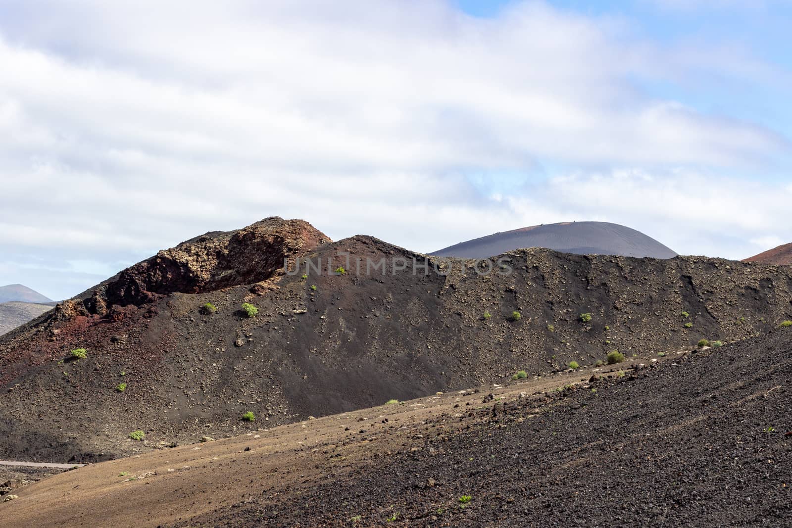 View at multi colored volcanic landscape in Timanfaya Nationalpark on canary island Lanzarote, Spain 