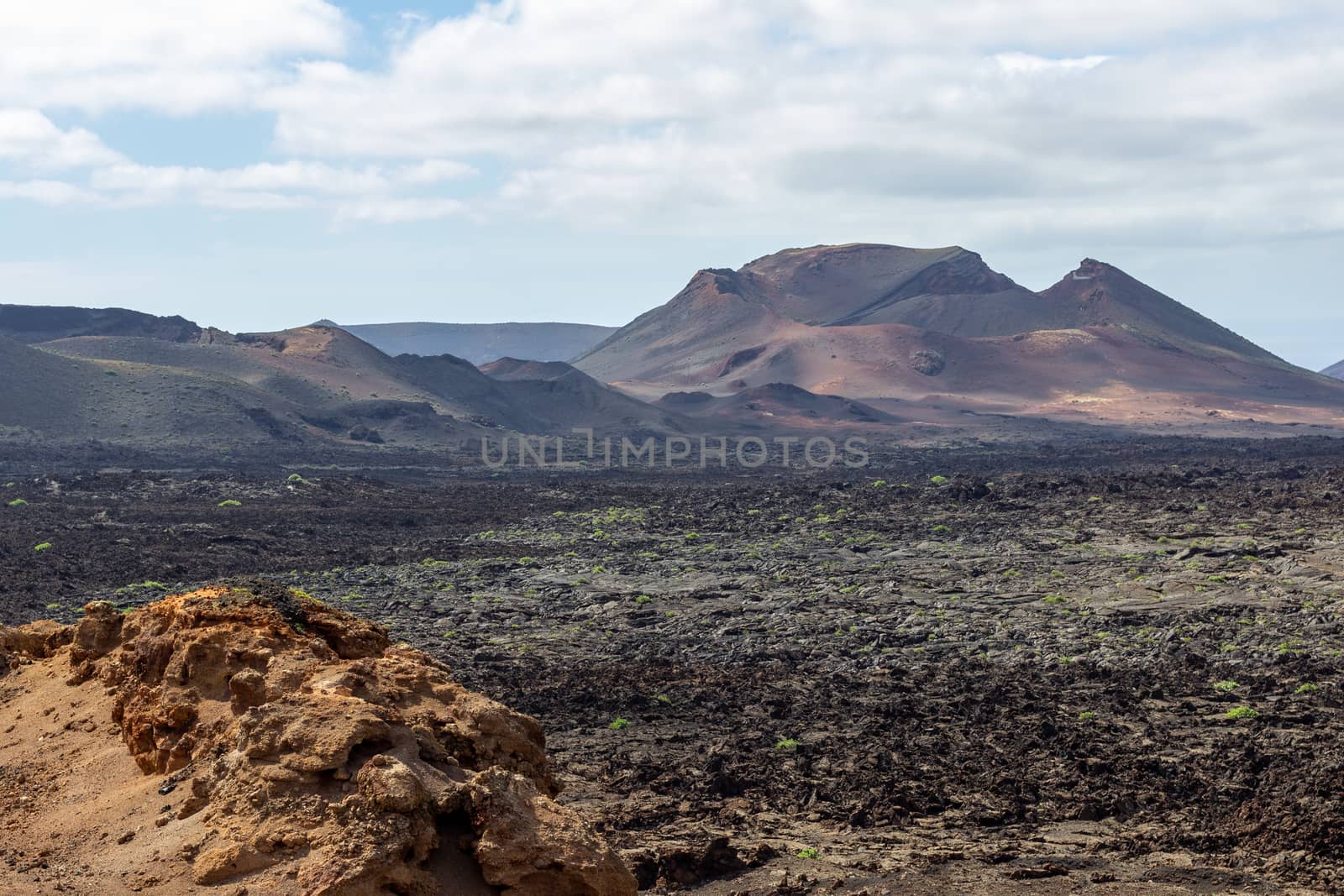 View at multi colored volcanic landscape in Timanfaya Nationalpark on canary island Lanzarote, Spain 