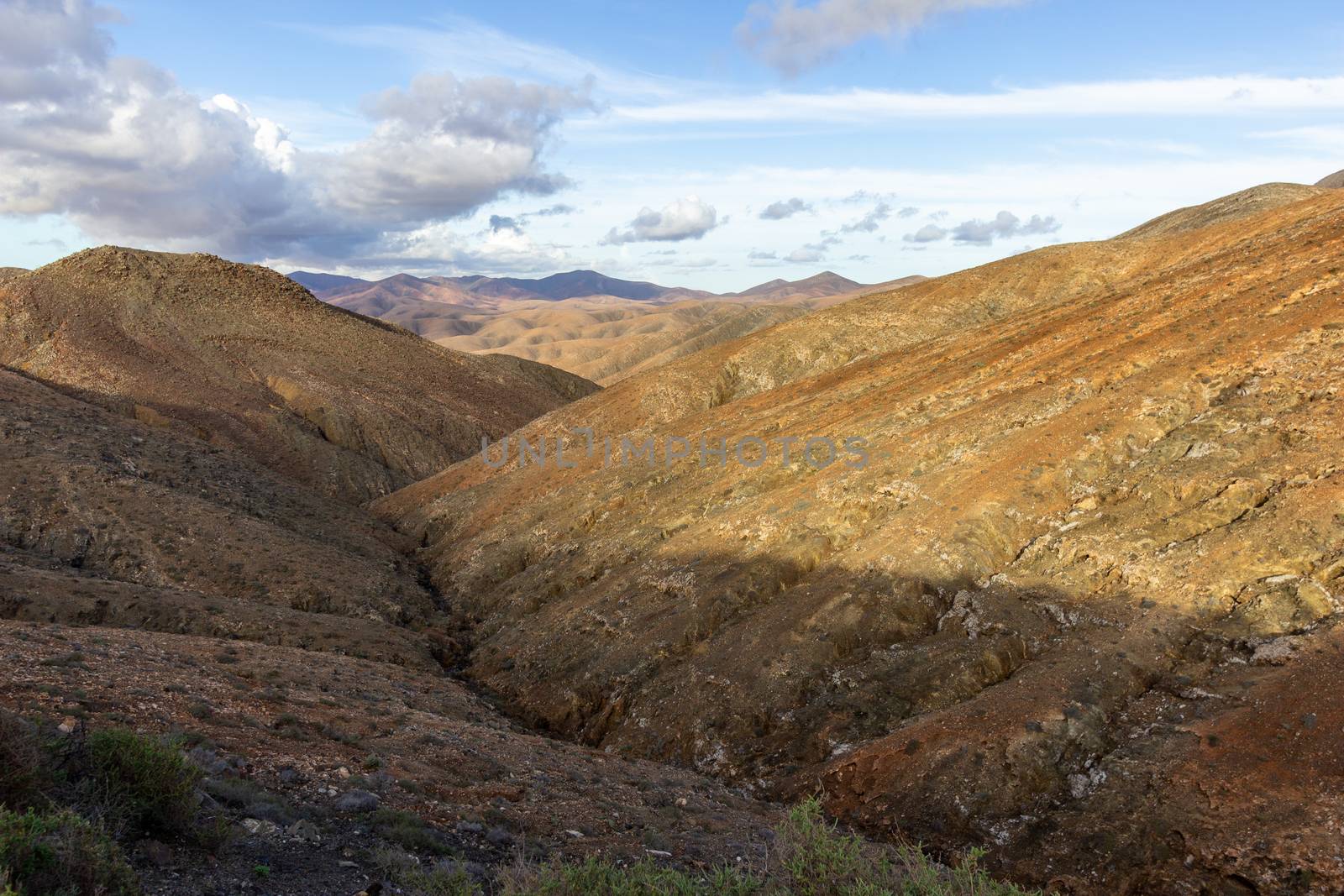 Panoramic view at landscape between Betancuria and Pajara  on Fuerteventura, Spain with multi colored volcanic hills and mountains