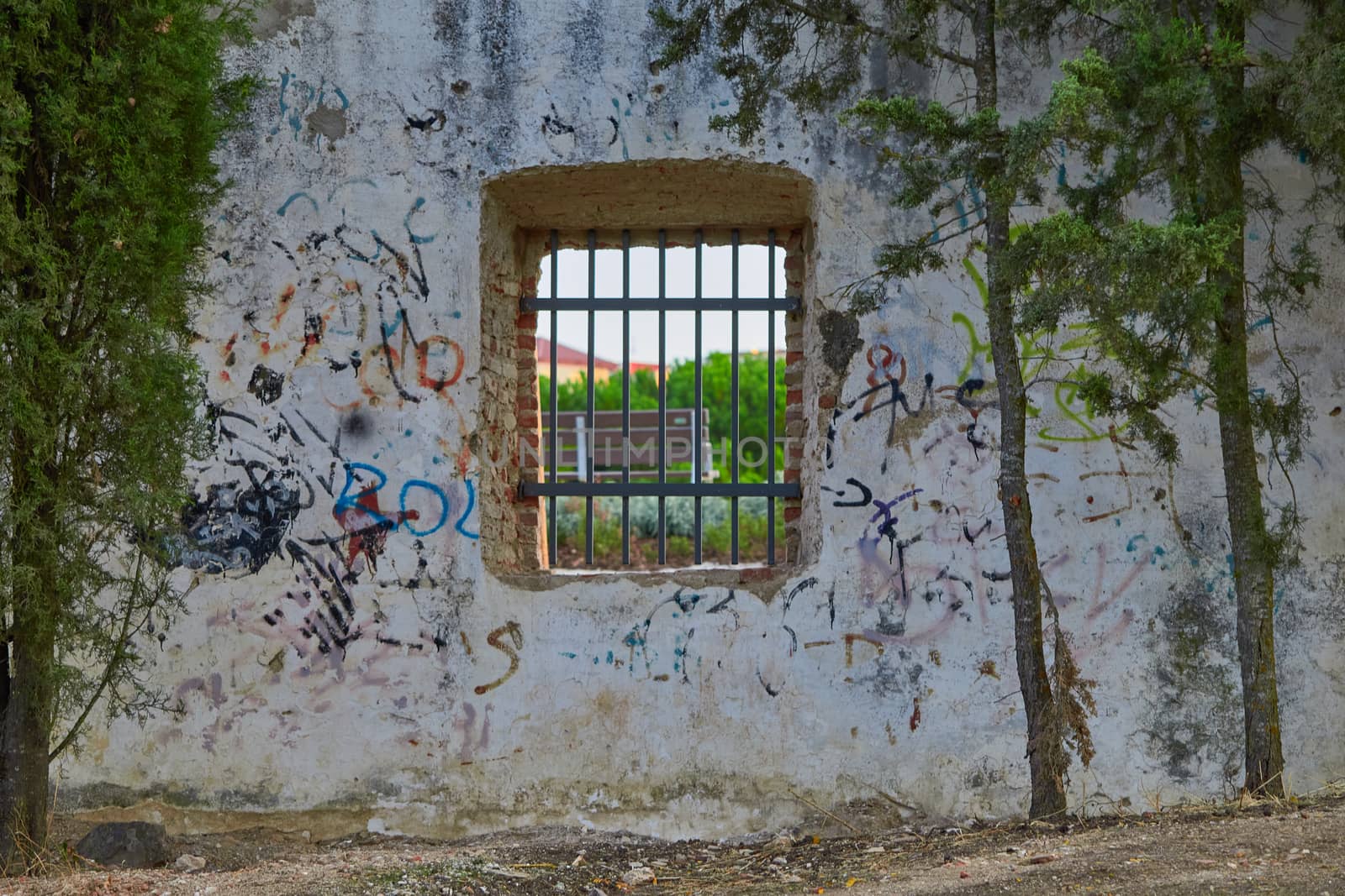 Window with rusty bars and graffiti by SoniaKarelitz
