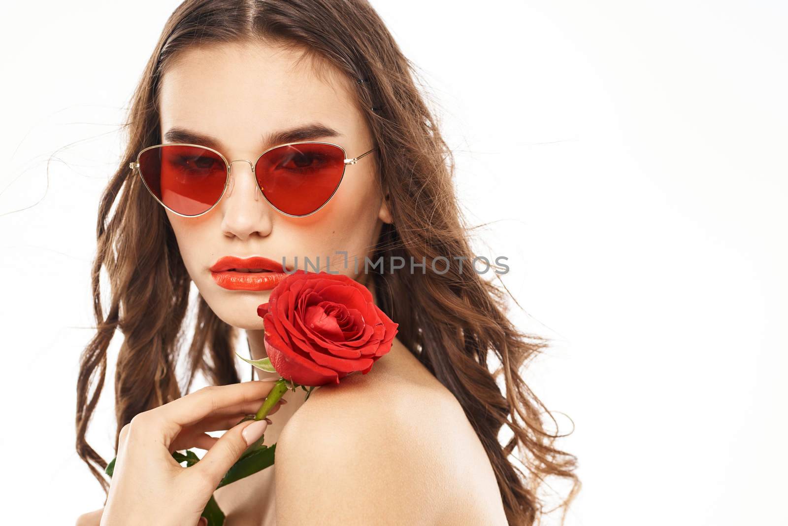 Brunette girl with red rose and sunglasses naked shoulders. High quality photo