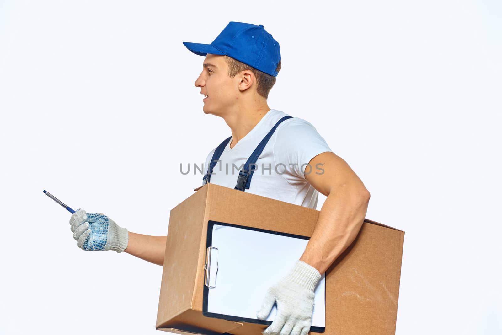 Man worker with box in hands delivery loading service work light background by SHOTPRIME