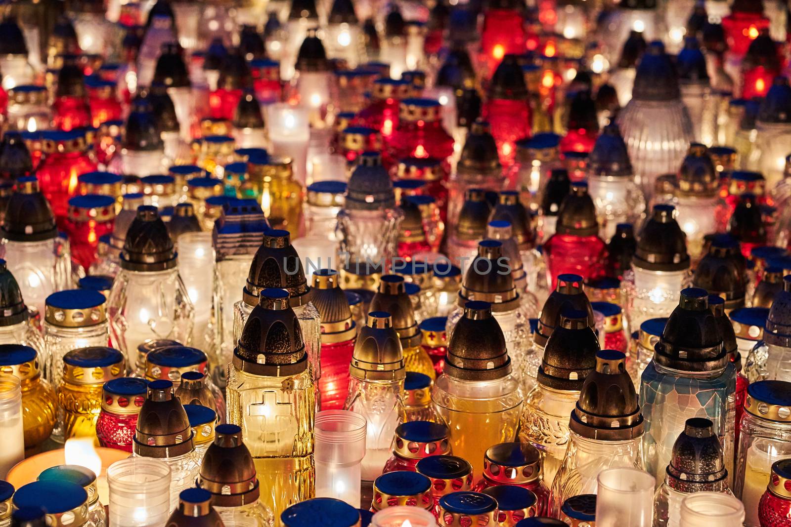 Candles burning on a grave in the cemetery of All Saints' Day in Poland