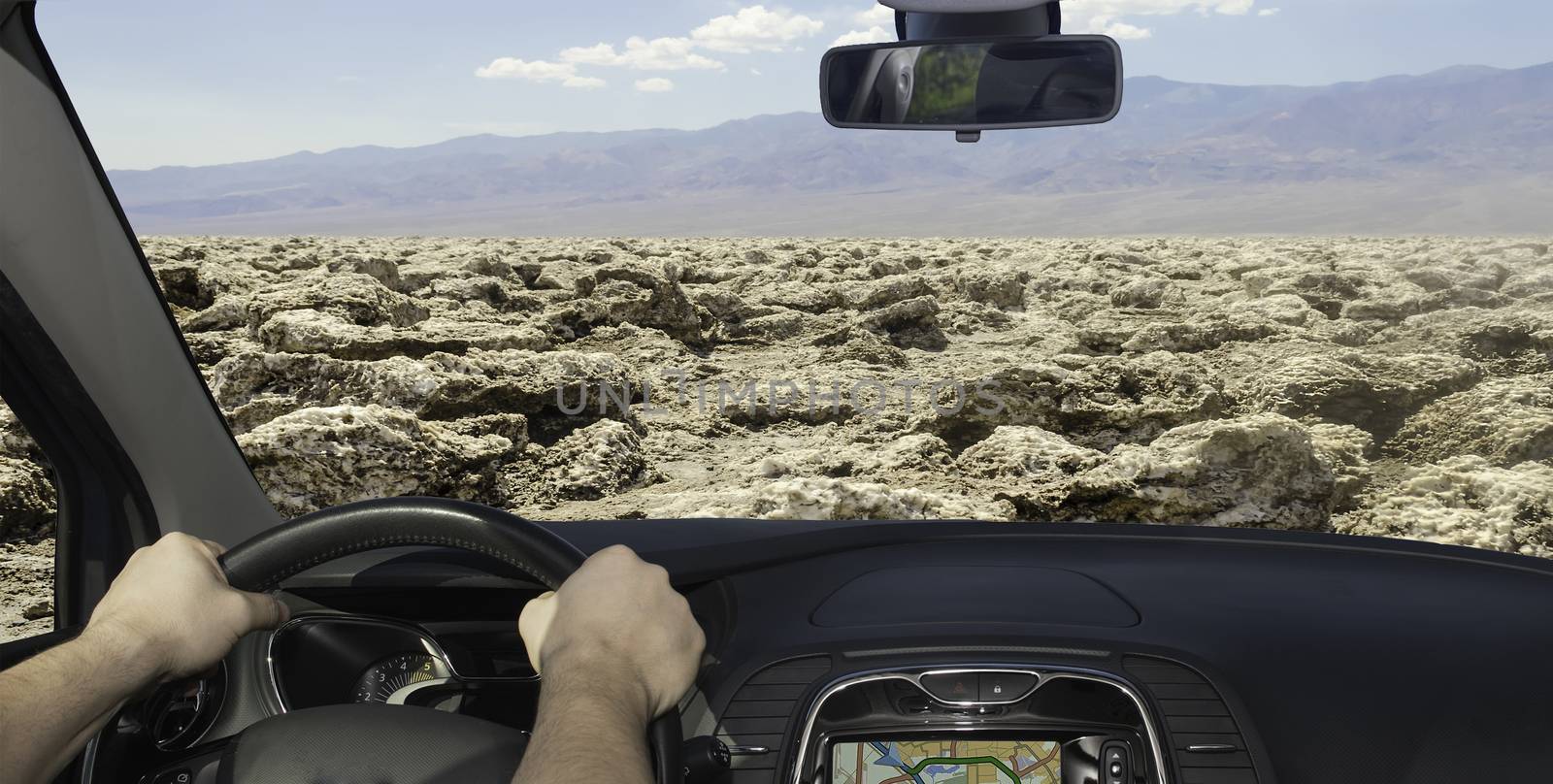 Driving a car towards the desert of Devil's Golf Course, Death Valley, USA