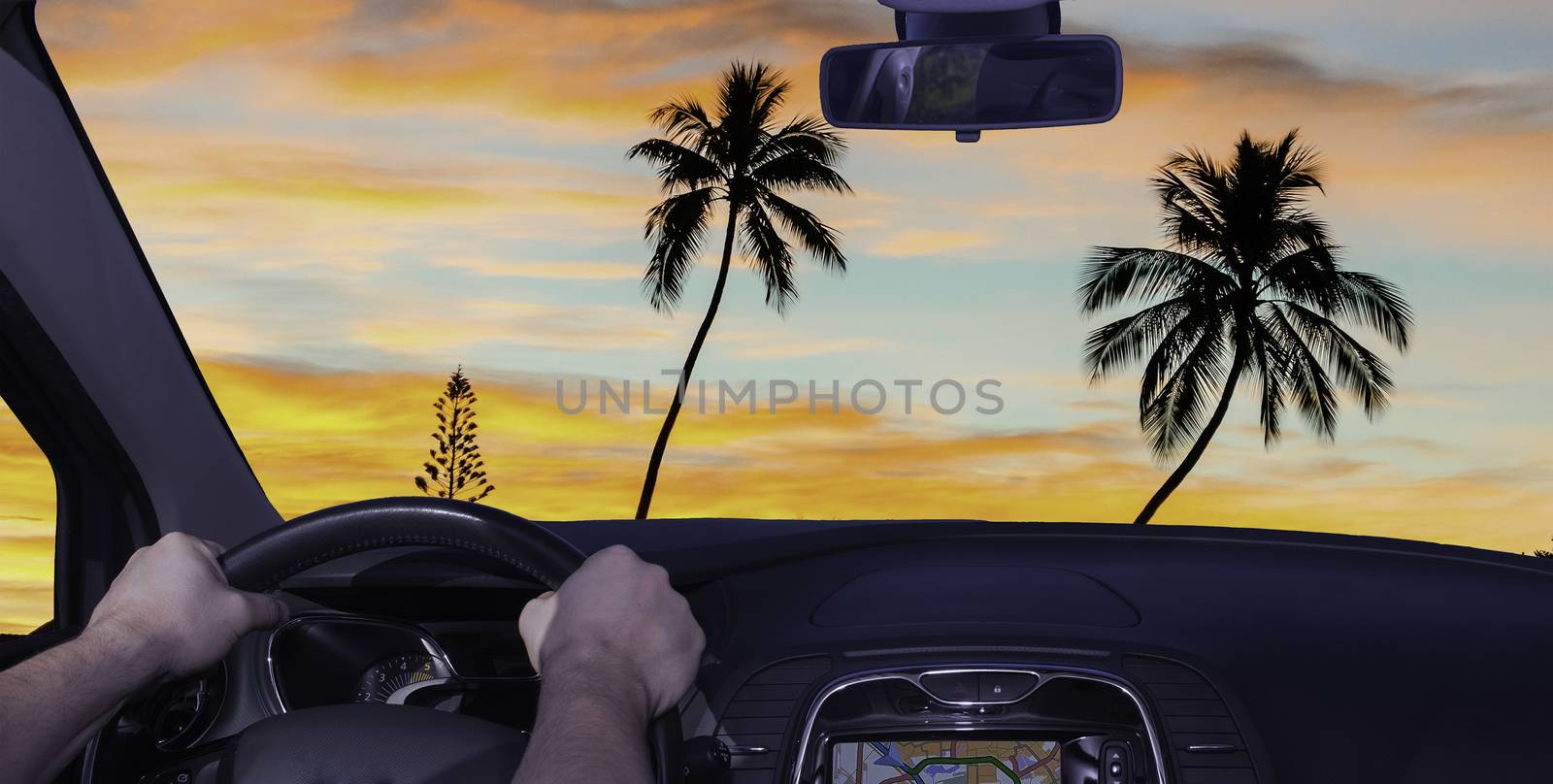 Driving a car towards a tropical sunset in Moorea, French Polynesia