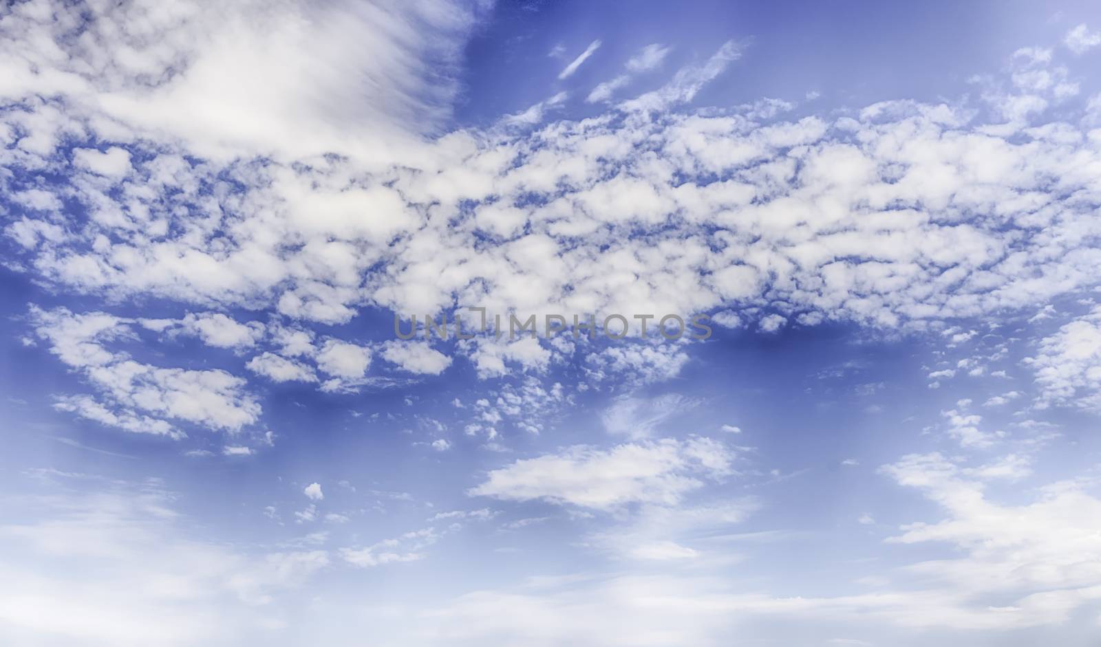Dramatic blue sky with scenic clouds texture with copy space, may be used as background