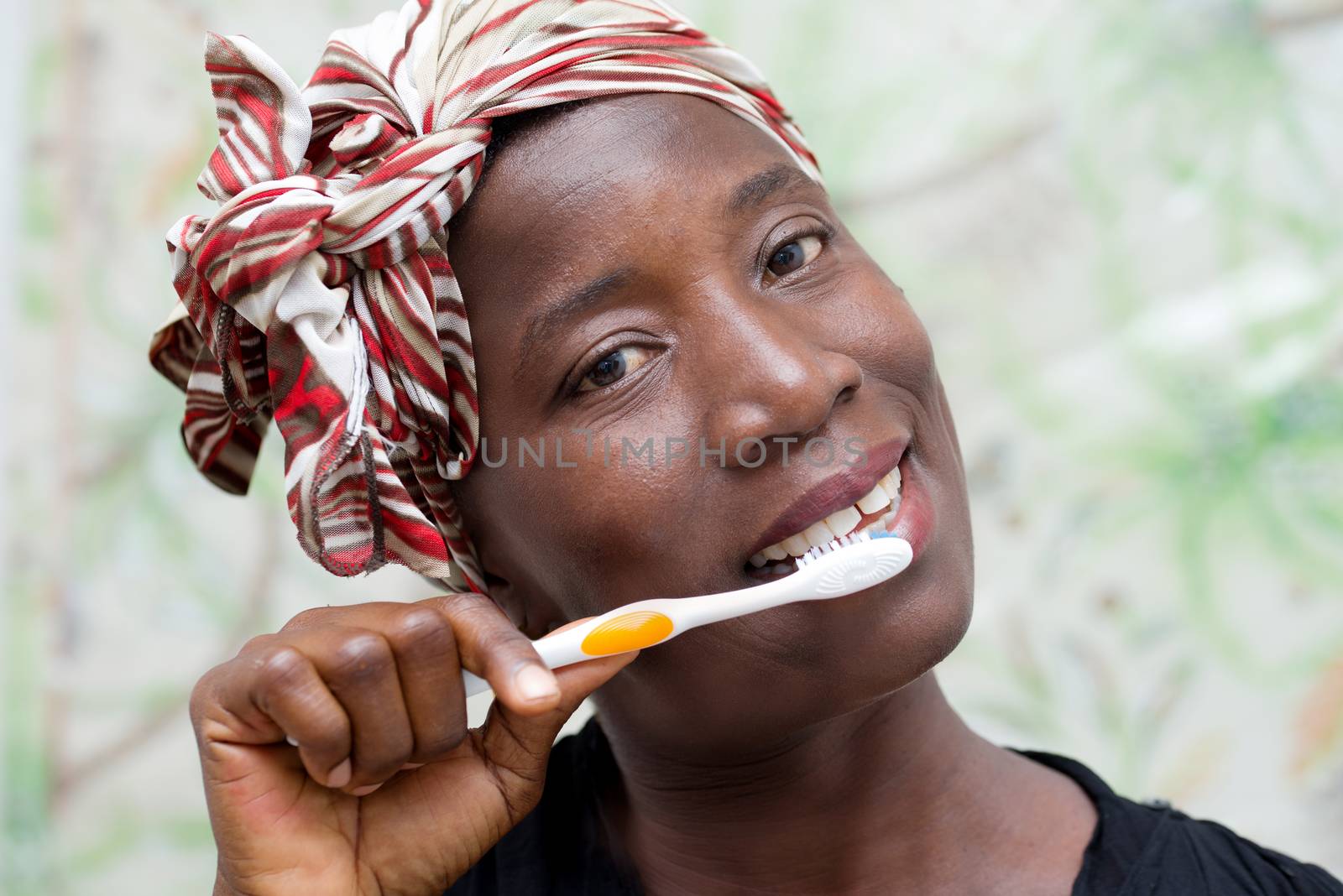 woman brushing teeth by vystek