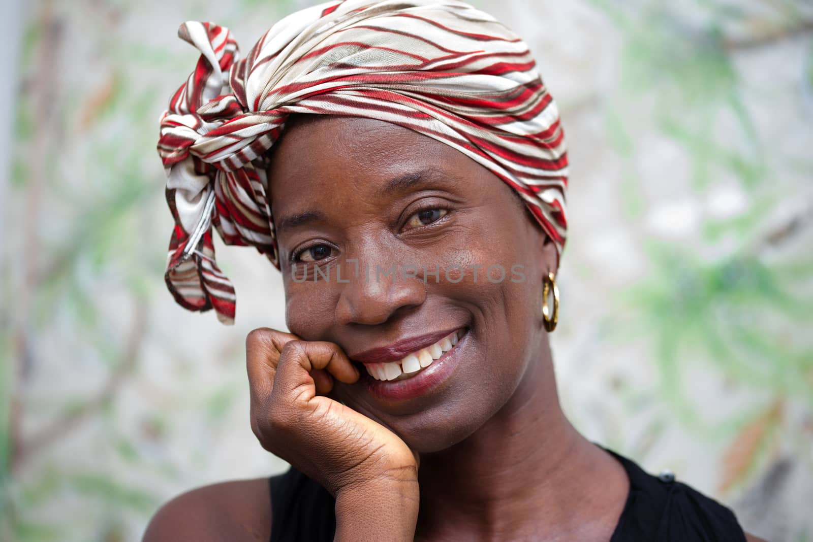 close-up of happy and attractive woman looking at camera on green background