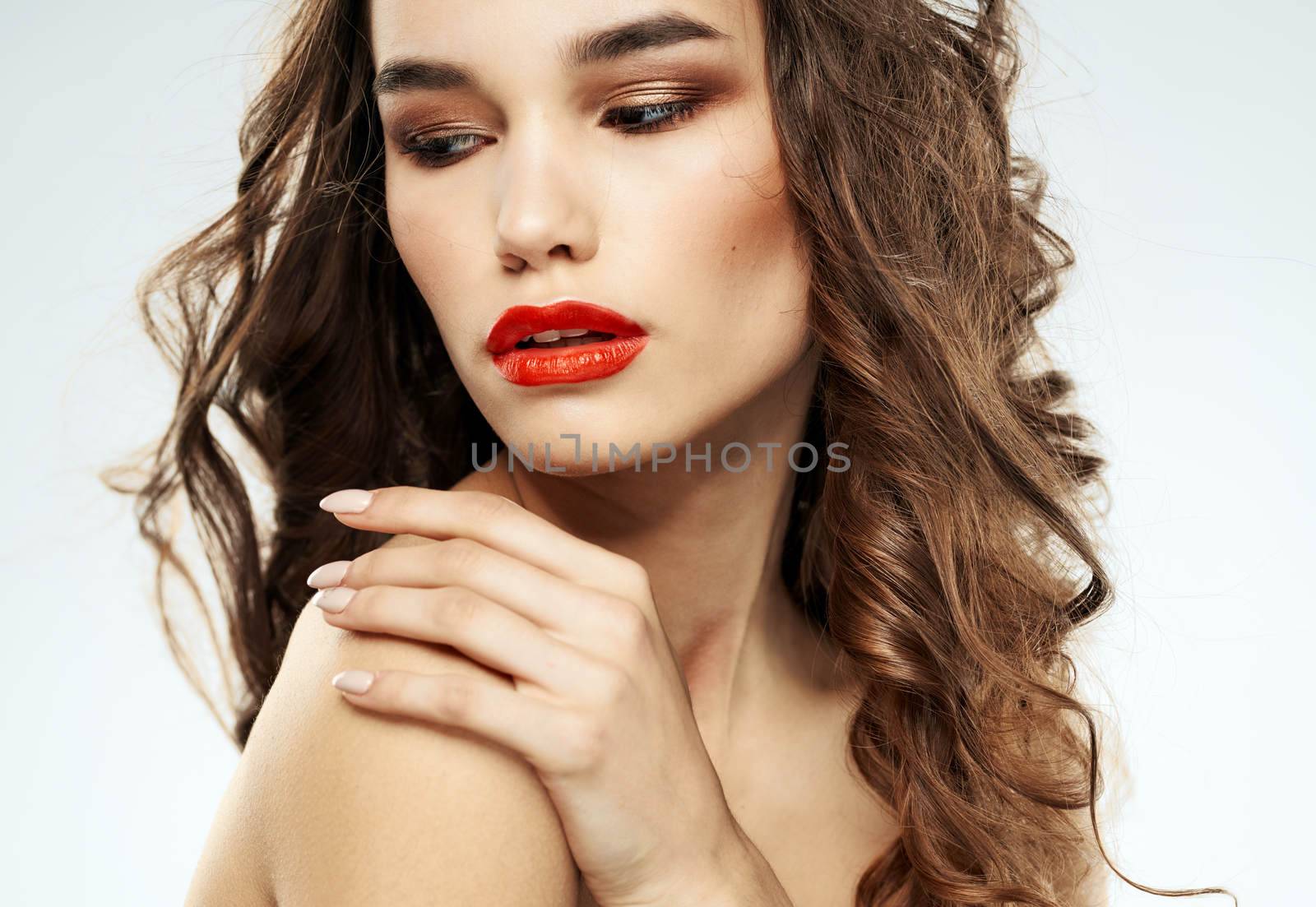Beautiful lady red lips curly hair makeup portrait. High quality photo