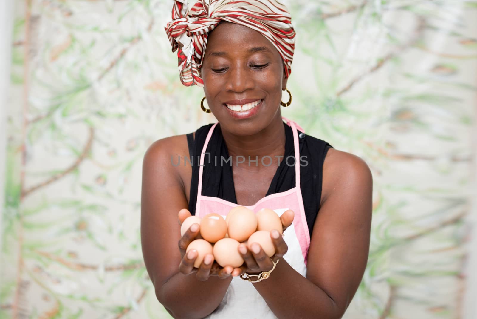 young smiling woman holding eggs in her hands