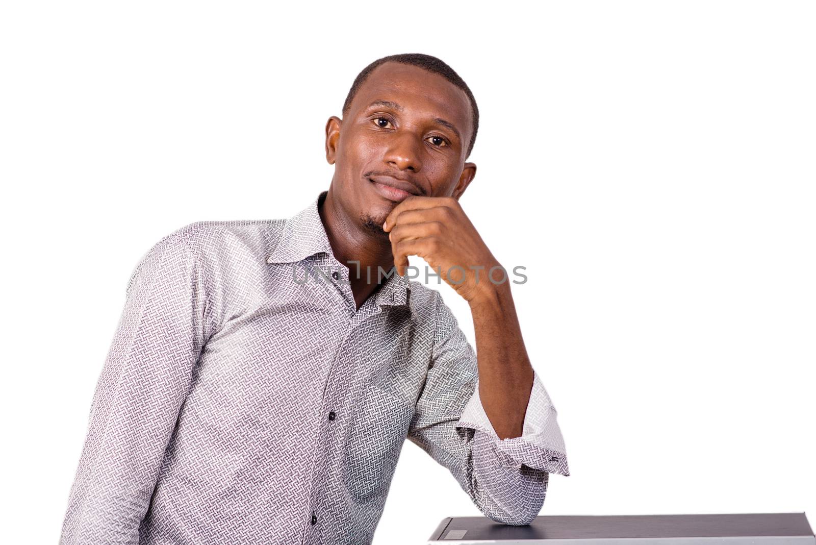 young technician leaning on computer equipment.