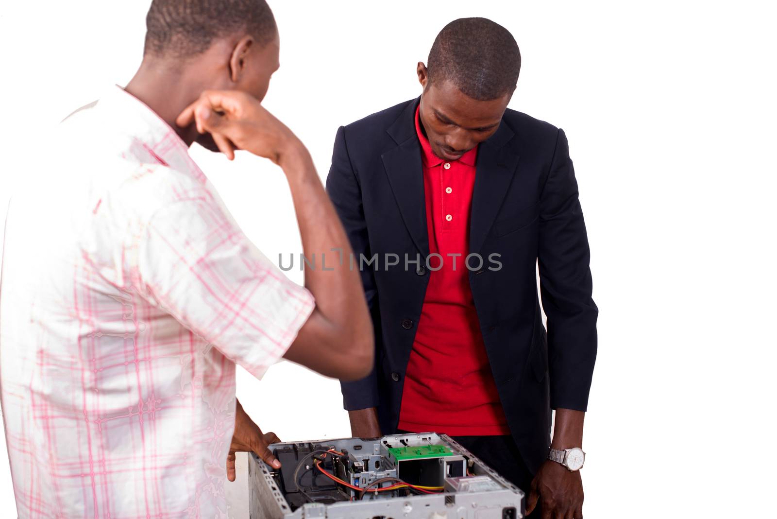 Technician repairing a broken down computer in an office in front of his boss