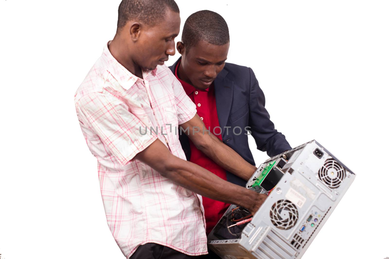 Technician repairing a broken down computer in an office in front of his boss