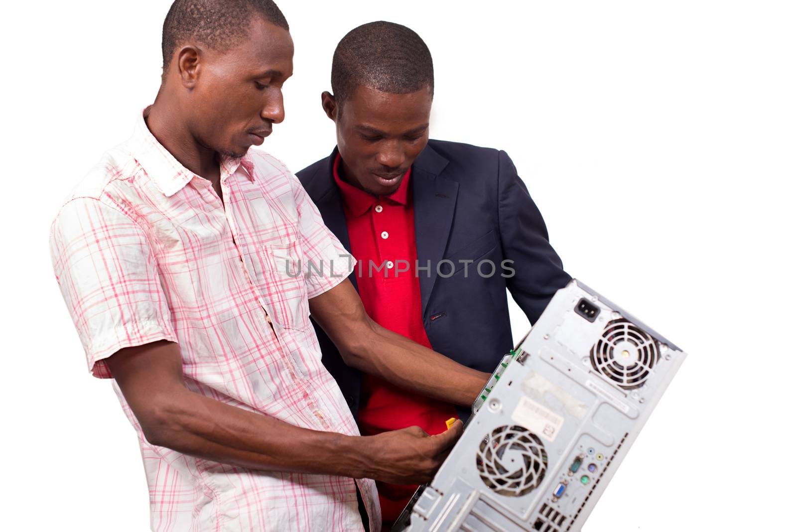 Technician repairing a broken down computer in an office in front of his boss