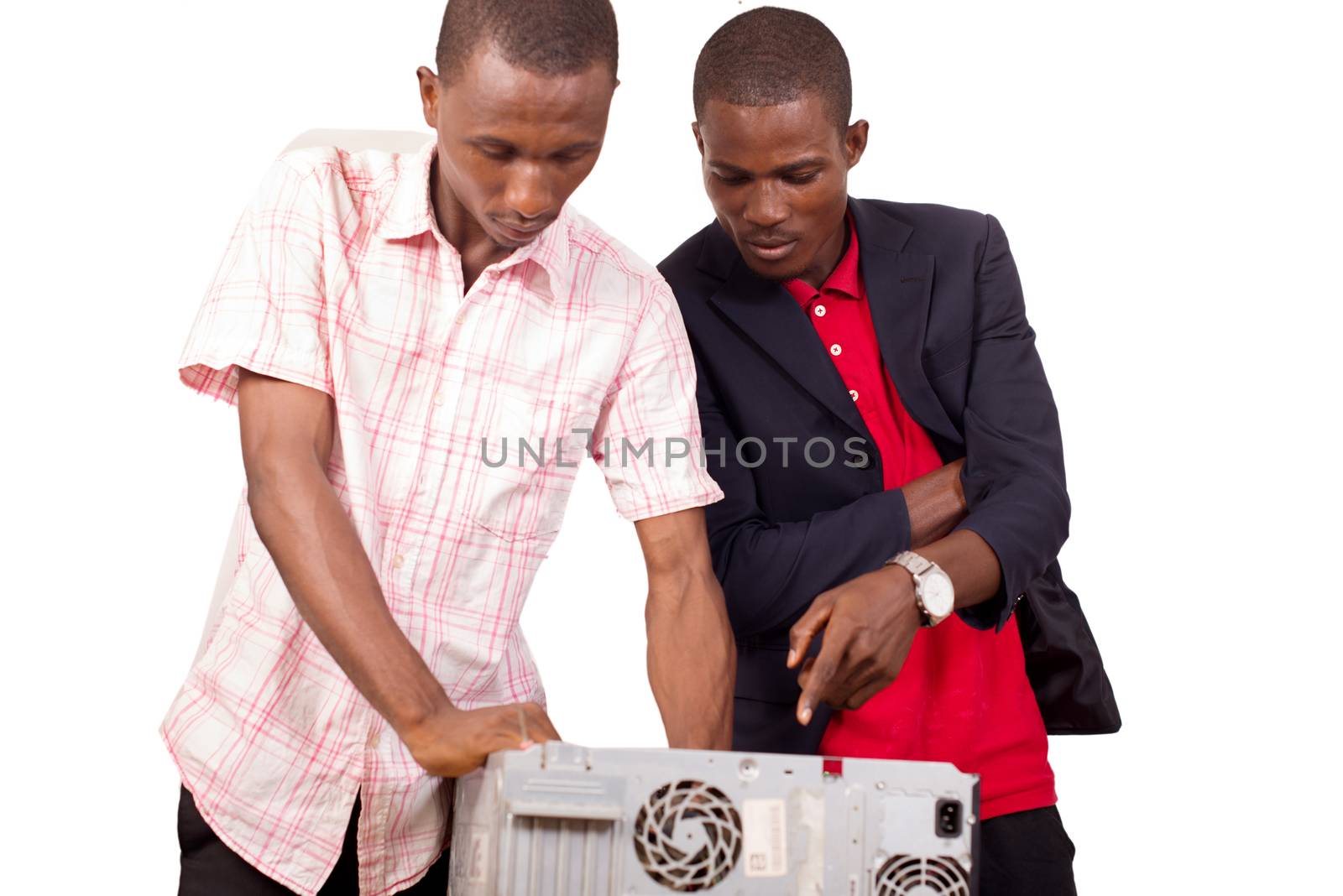 Technician repairing a broken down computer in an office in front of his boss