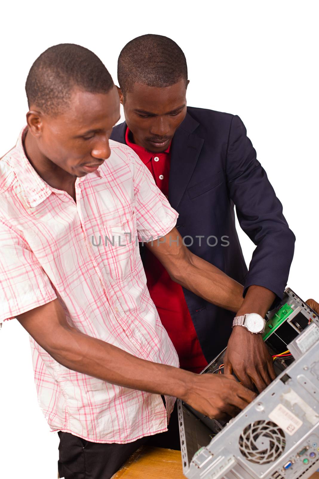 Technician repairing a computer in an office in front of his boss