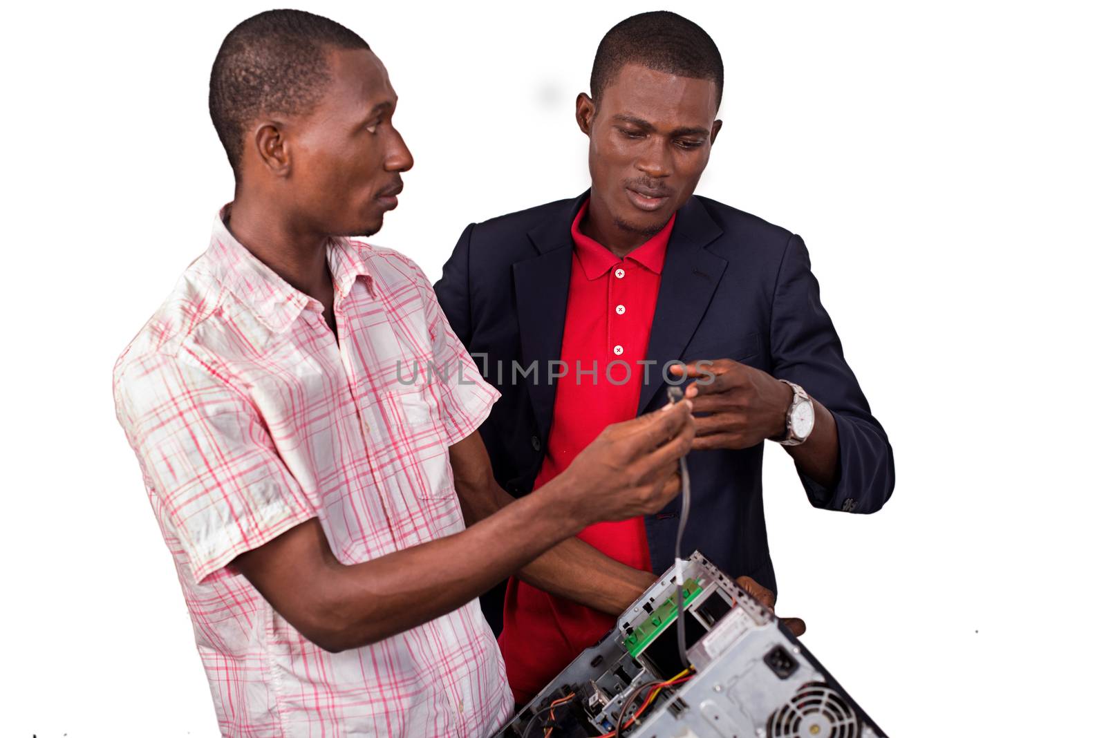 Technician repairing a computer in an office in front of his boss