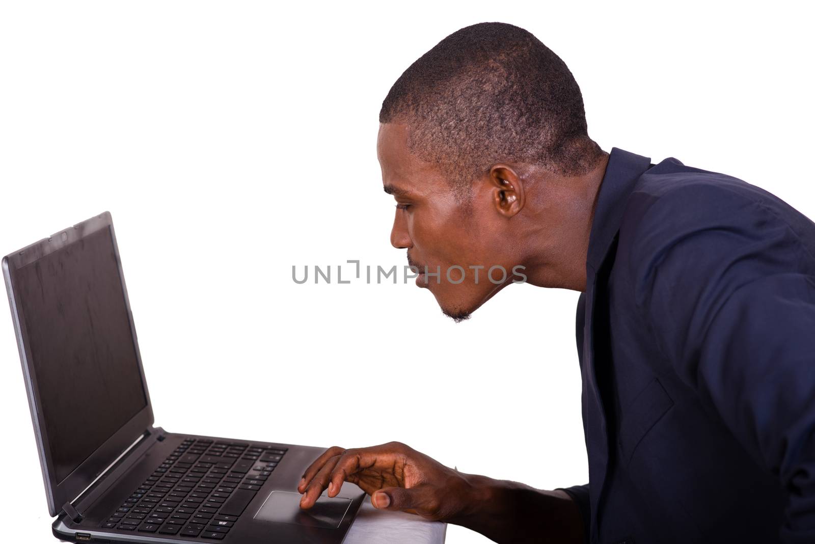 young businessman looking at his computer screen and absorbed by the work