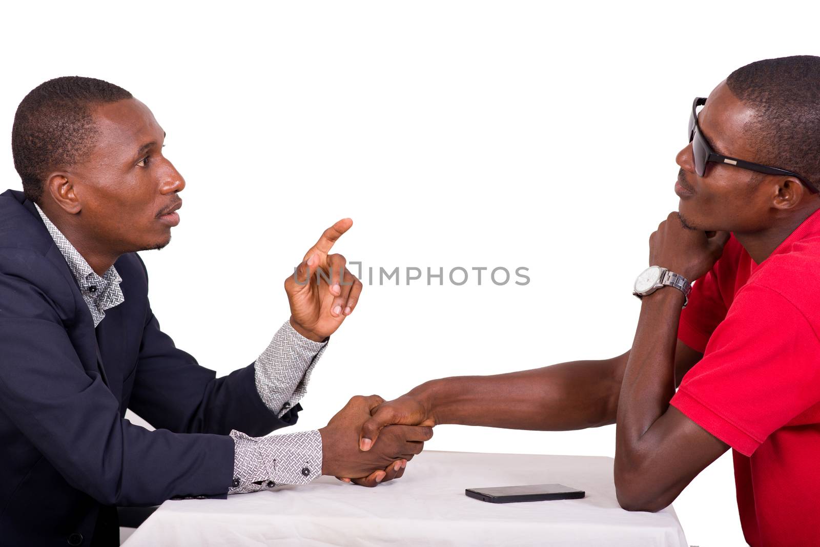 two men sitting around a table and greeting each other at a restaurant business meeting