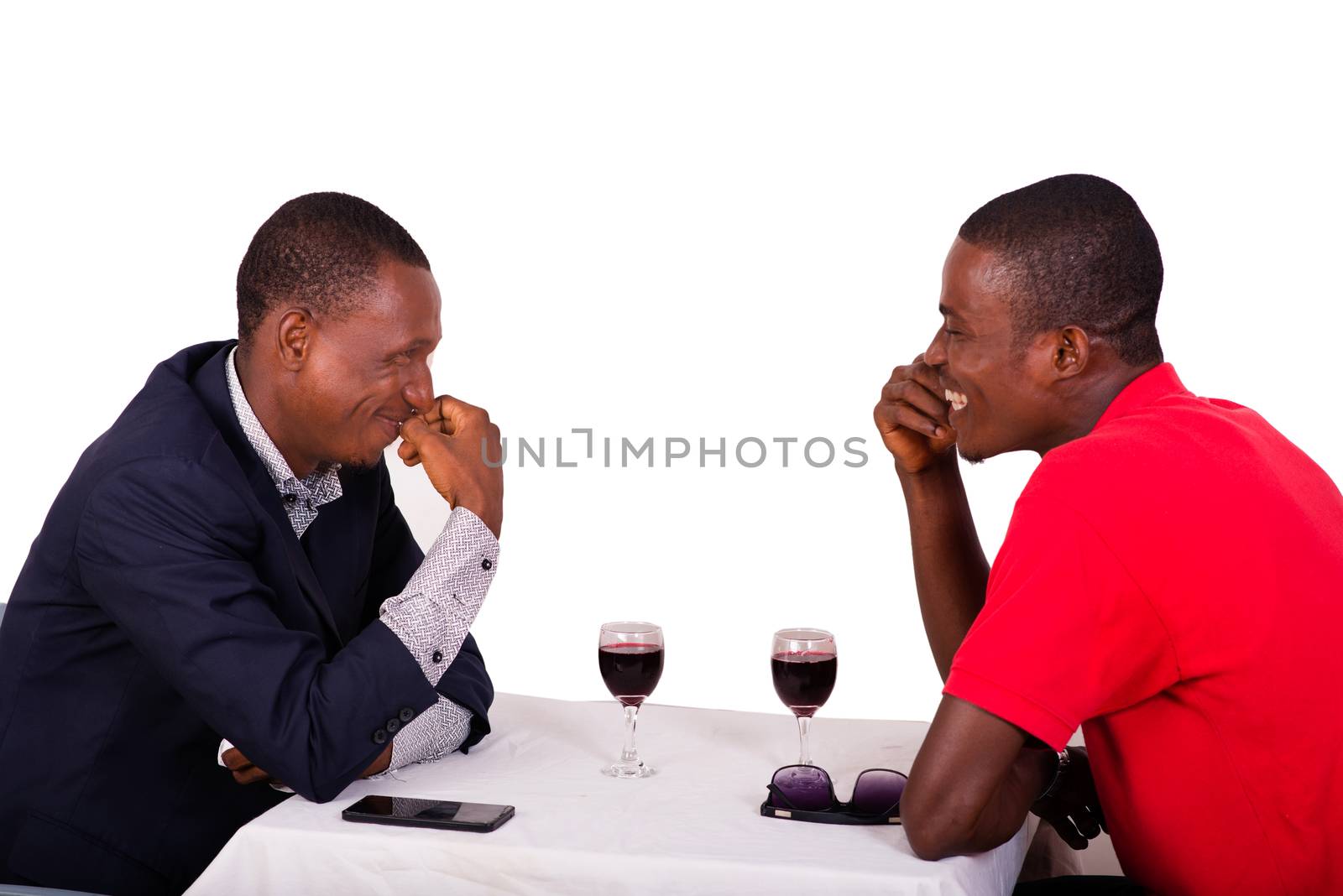 Group of happy people drink wine at the table and discuss together about their business,