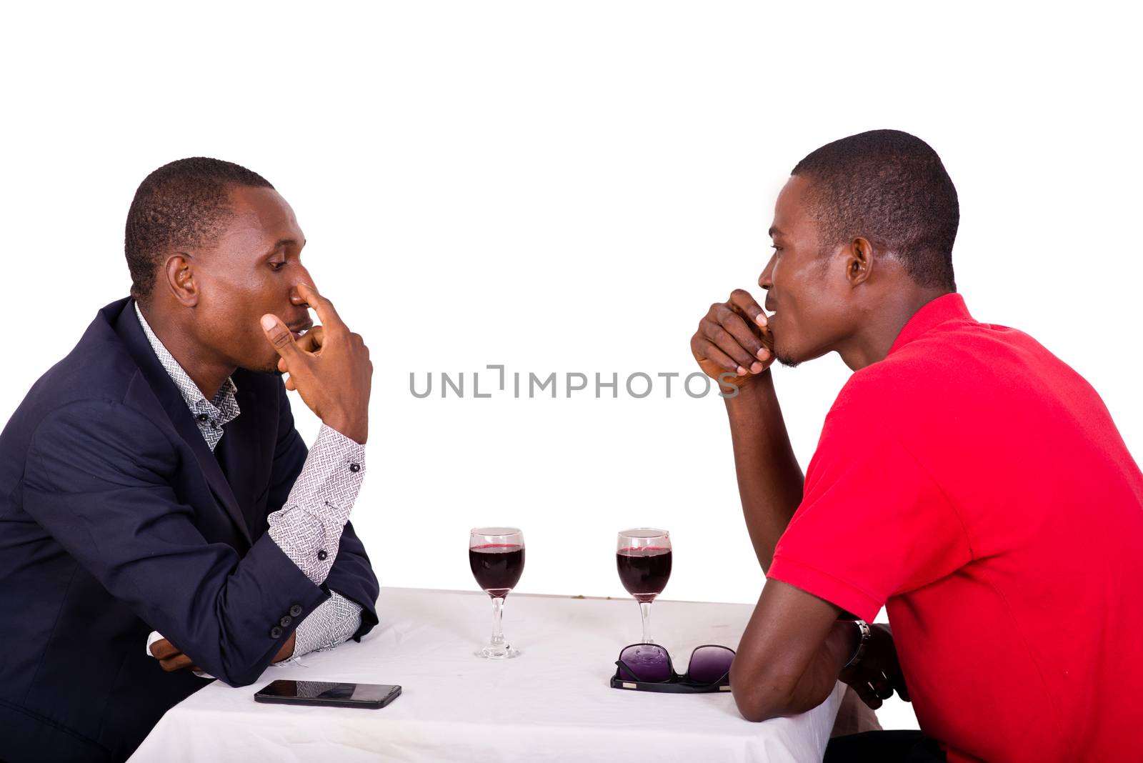 Group of happy people drink wine at the table and discuss together about their business,