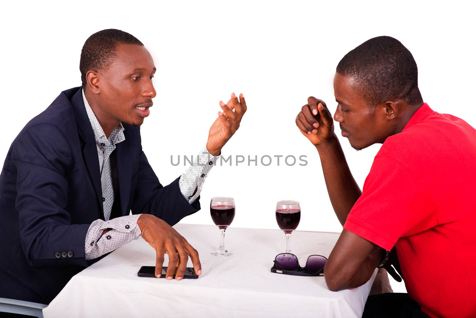 two business people sitting at the restaurant talking business drinking wine together