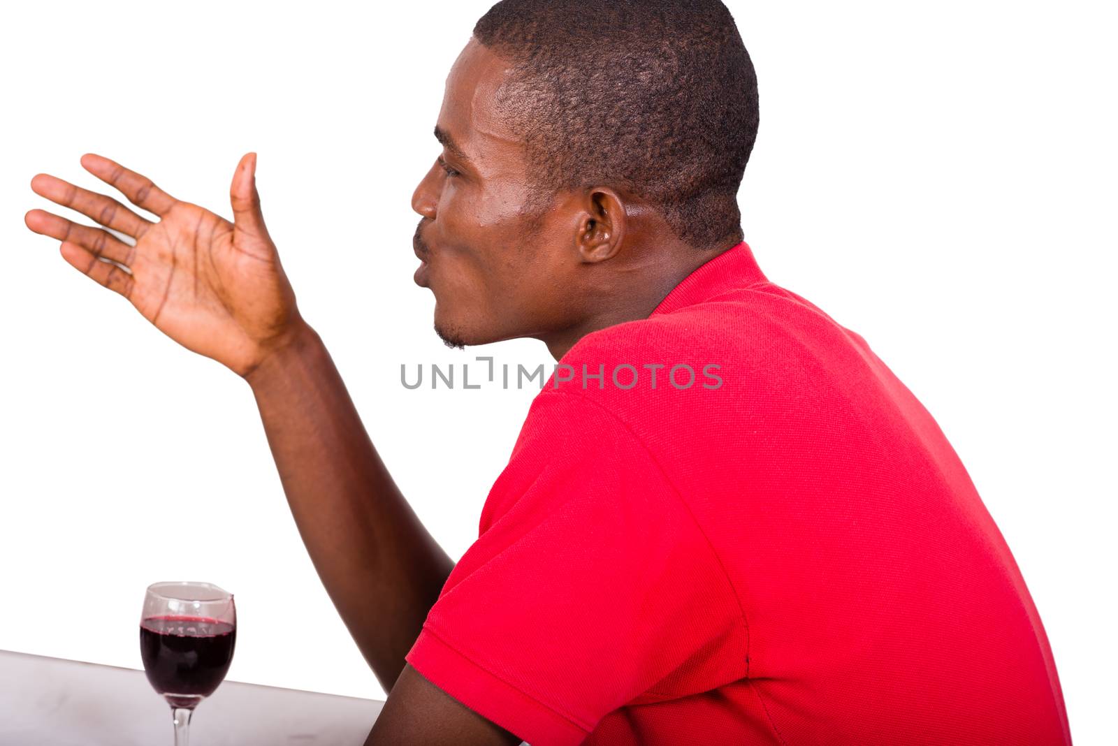 young men sitting at the restaurant in front of a glass of wine and talking alone