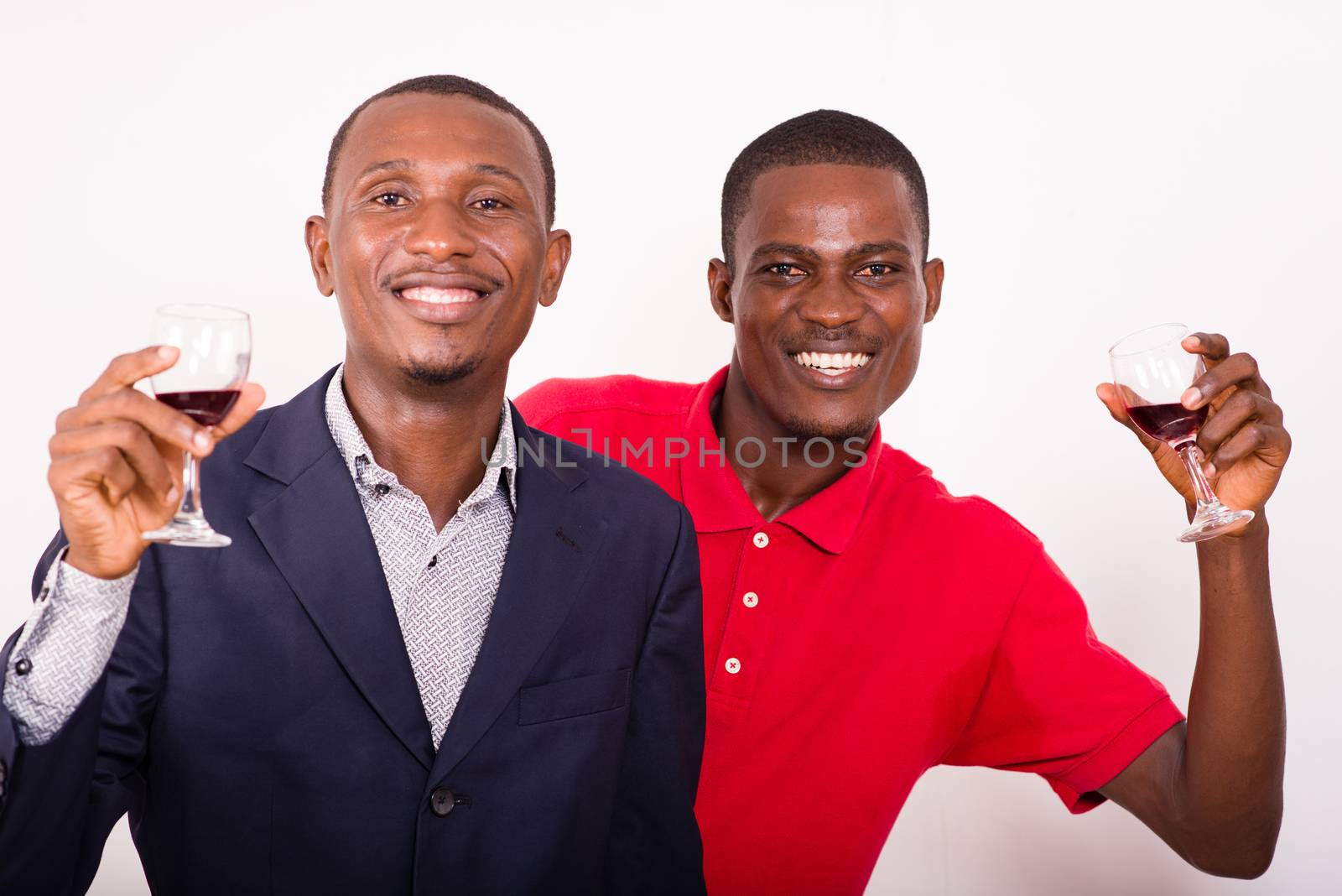 Young happy people toasting with wine for a party in studio on a white background