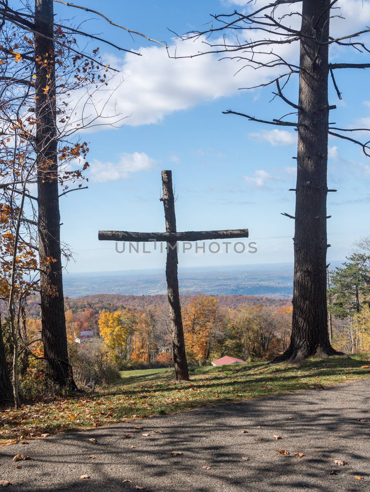 Wooden cross overlooking fall trees near Uniontown, Pennsylvania by steheap