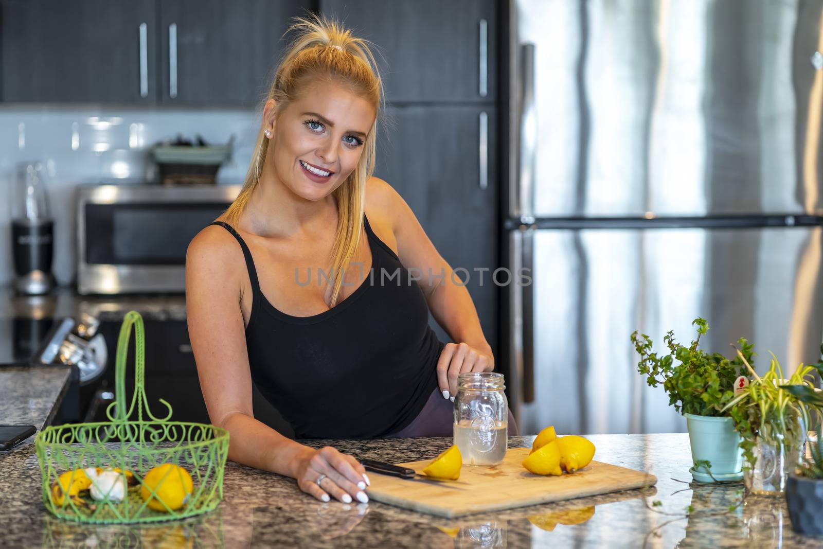 A gorgeous blonde model prepares a meal before heading to work