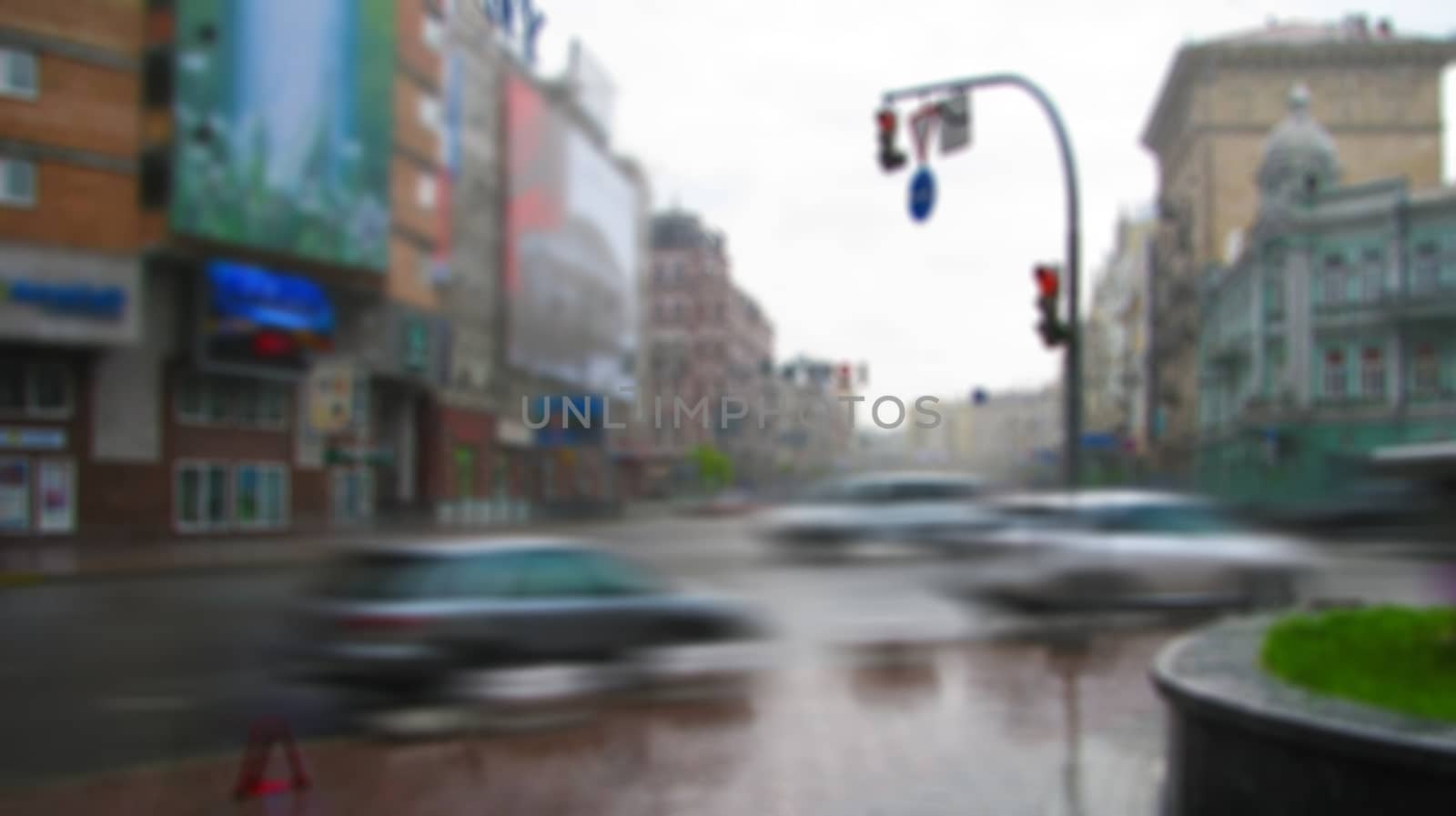 A city street with moving cars in a creative storyline with a blurred image surface