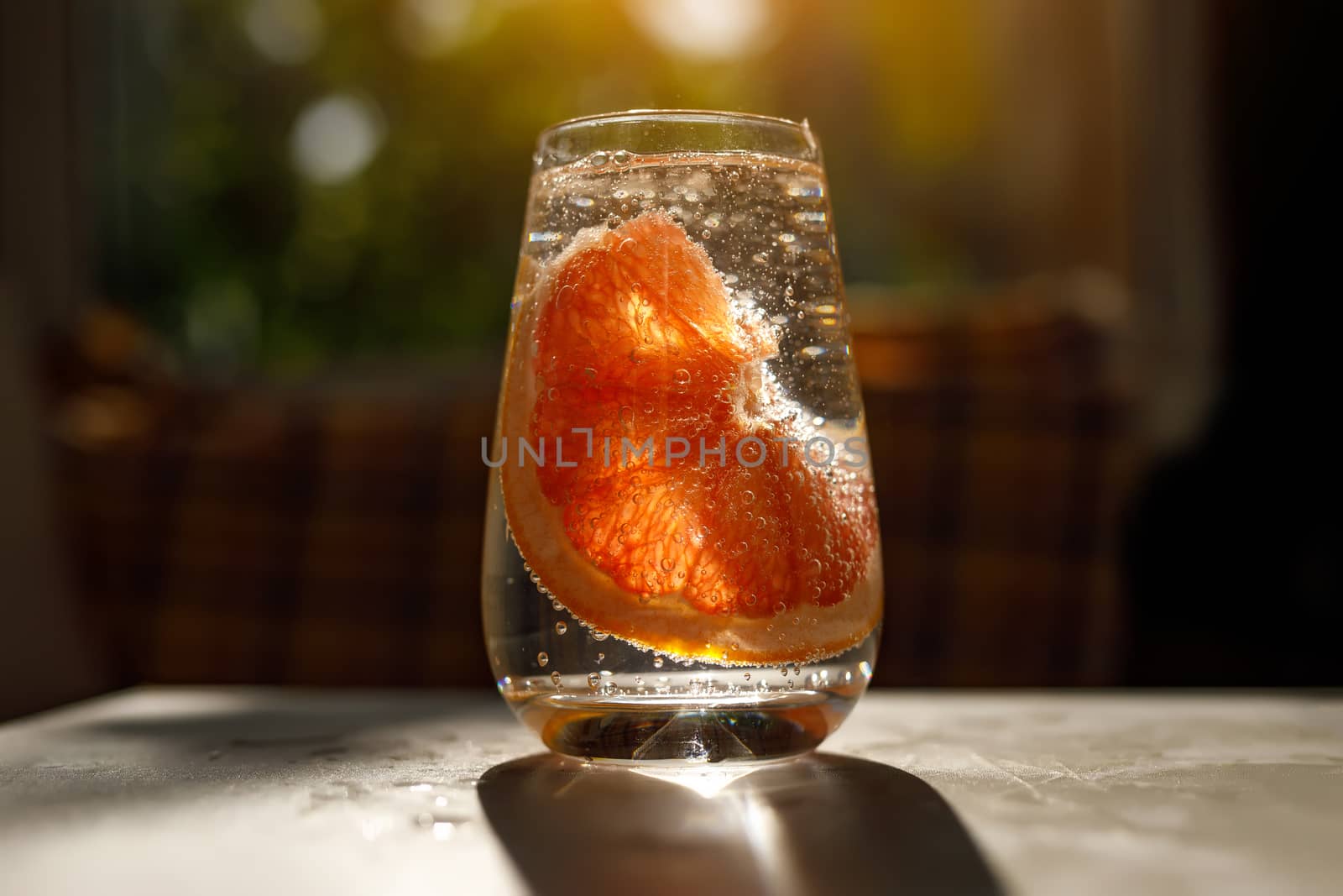 A glass of water with grapefruit